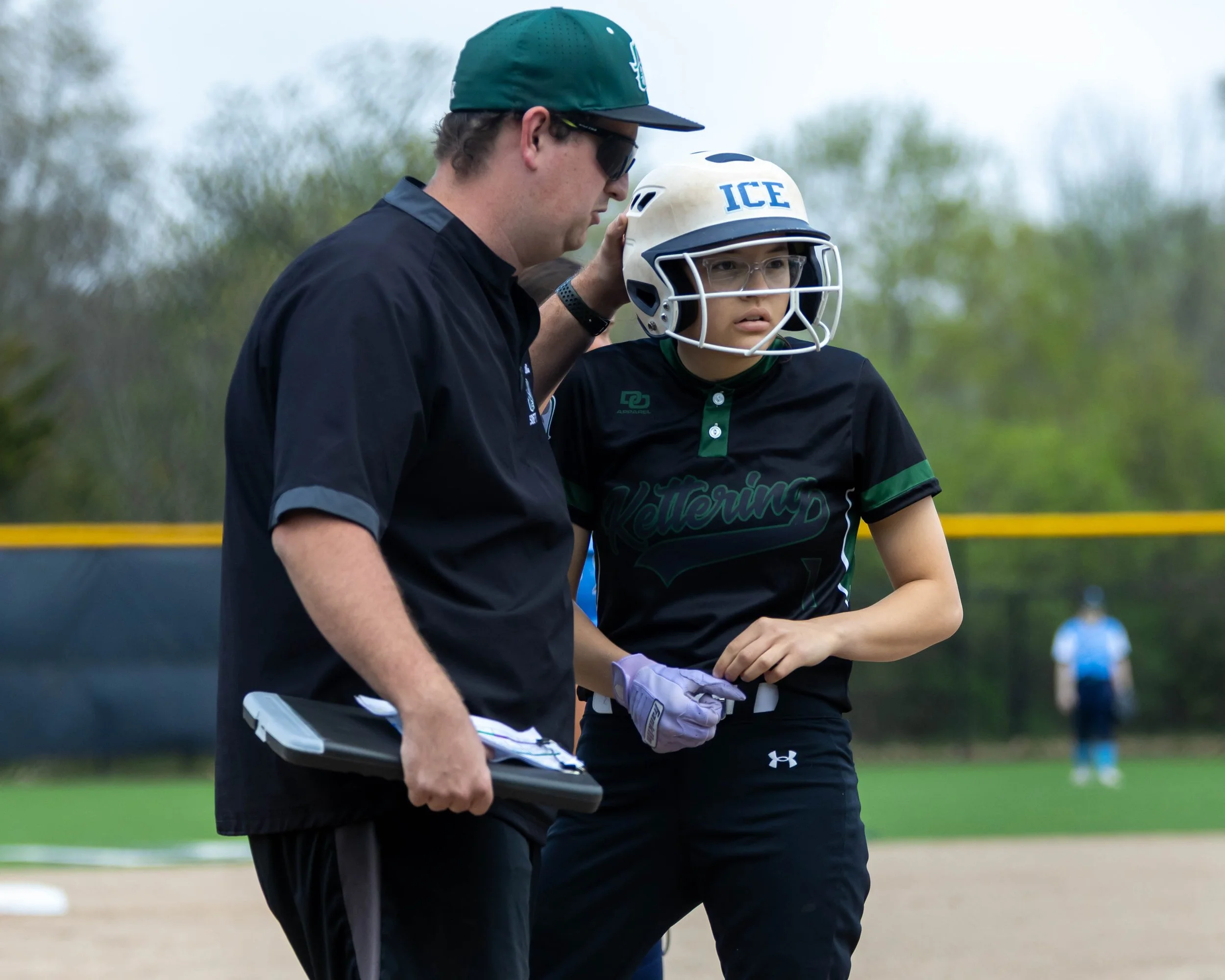 Kettering #1 talks with coach at third base