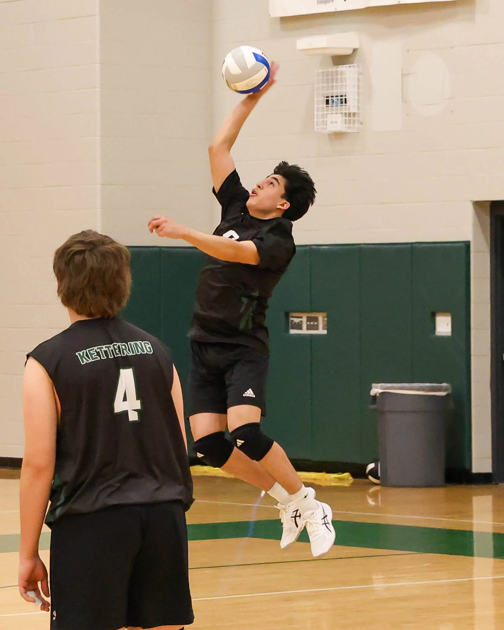 Kettering #9 serves the ball