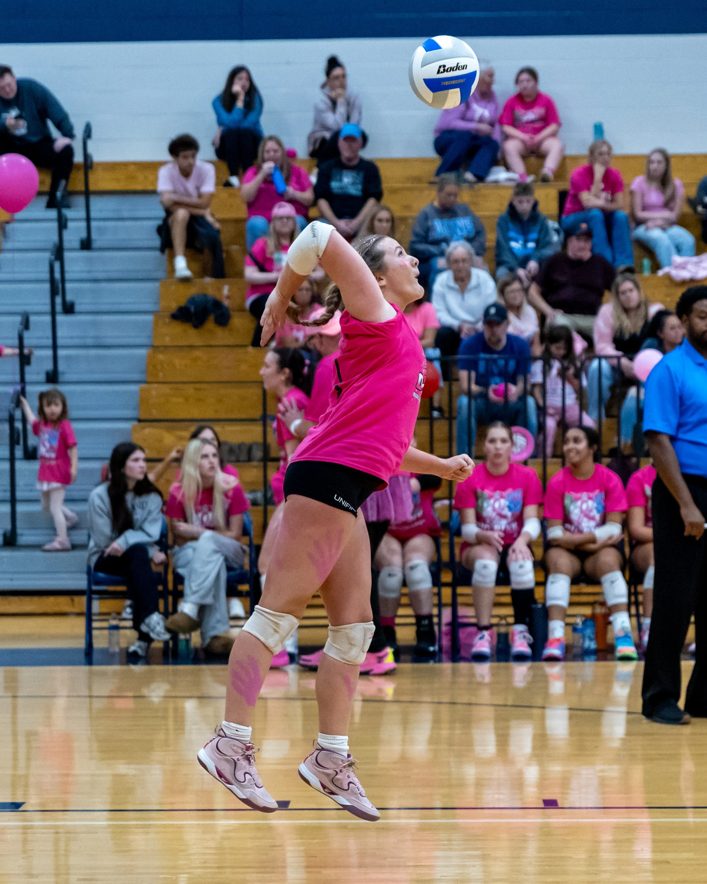 Kettering player serves the ball