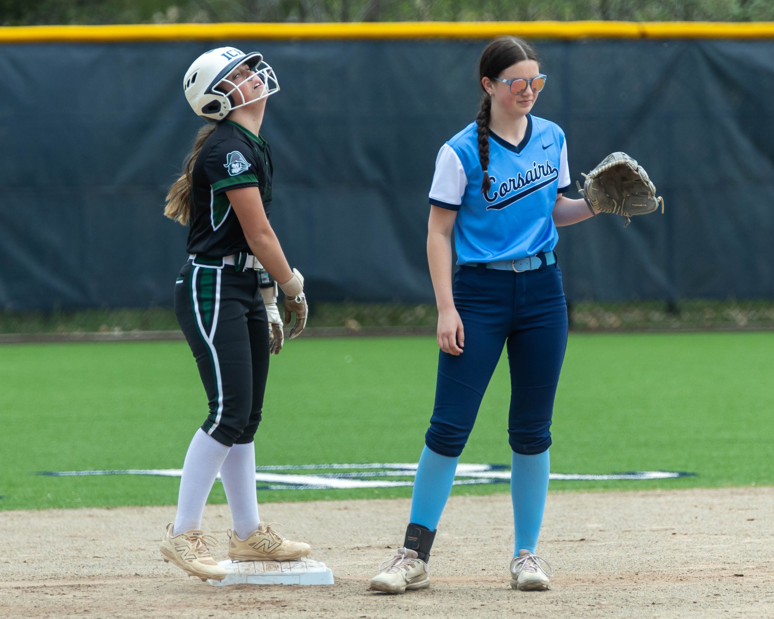 Kettering #99 stands at second base with the Mott second base 