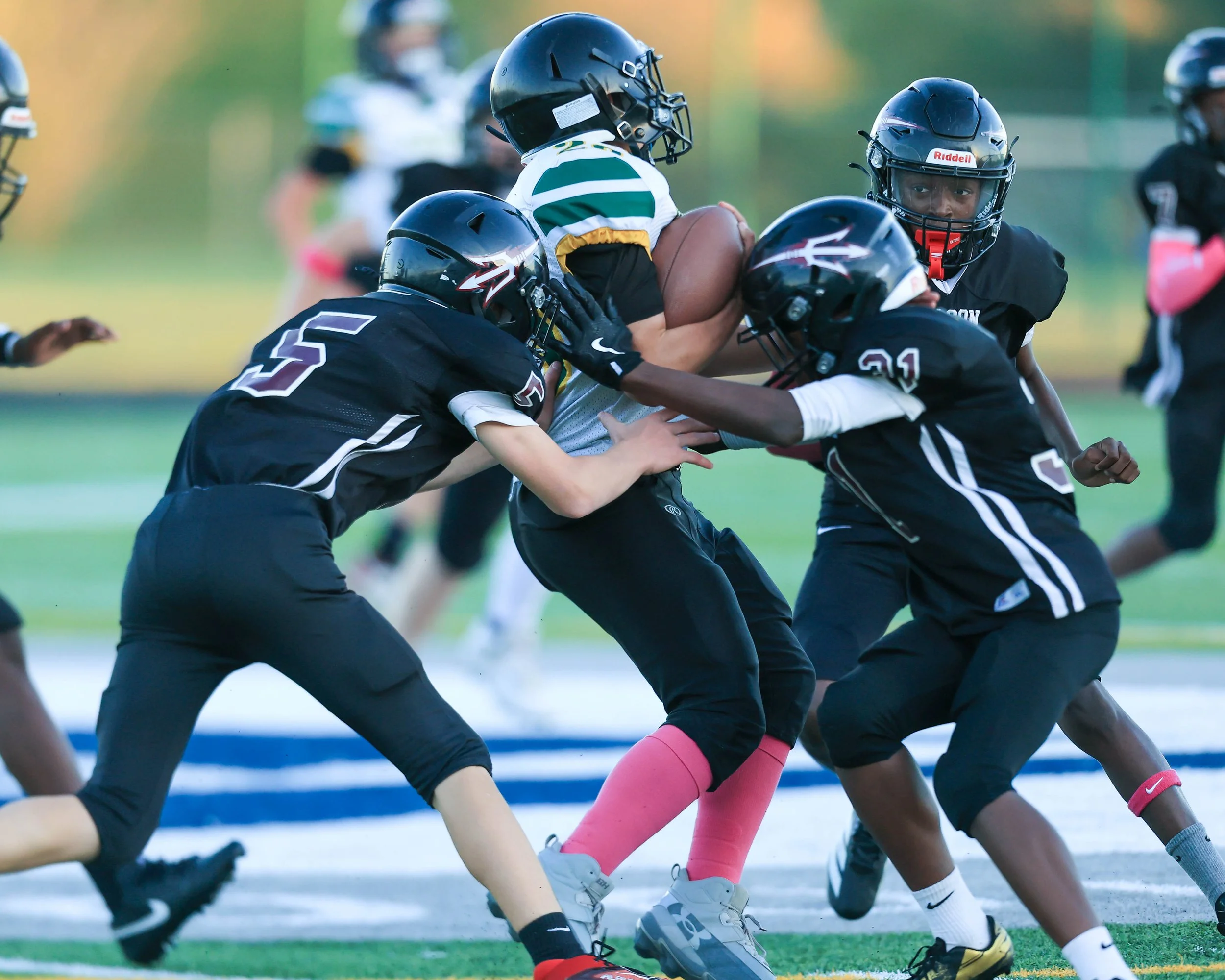 Pierce #26 tackled by Mason #5 and #31