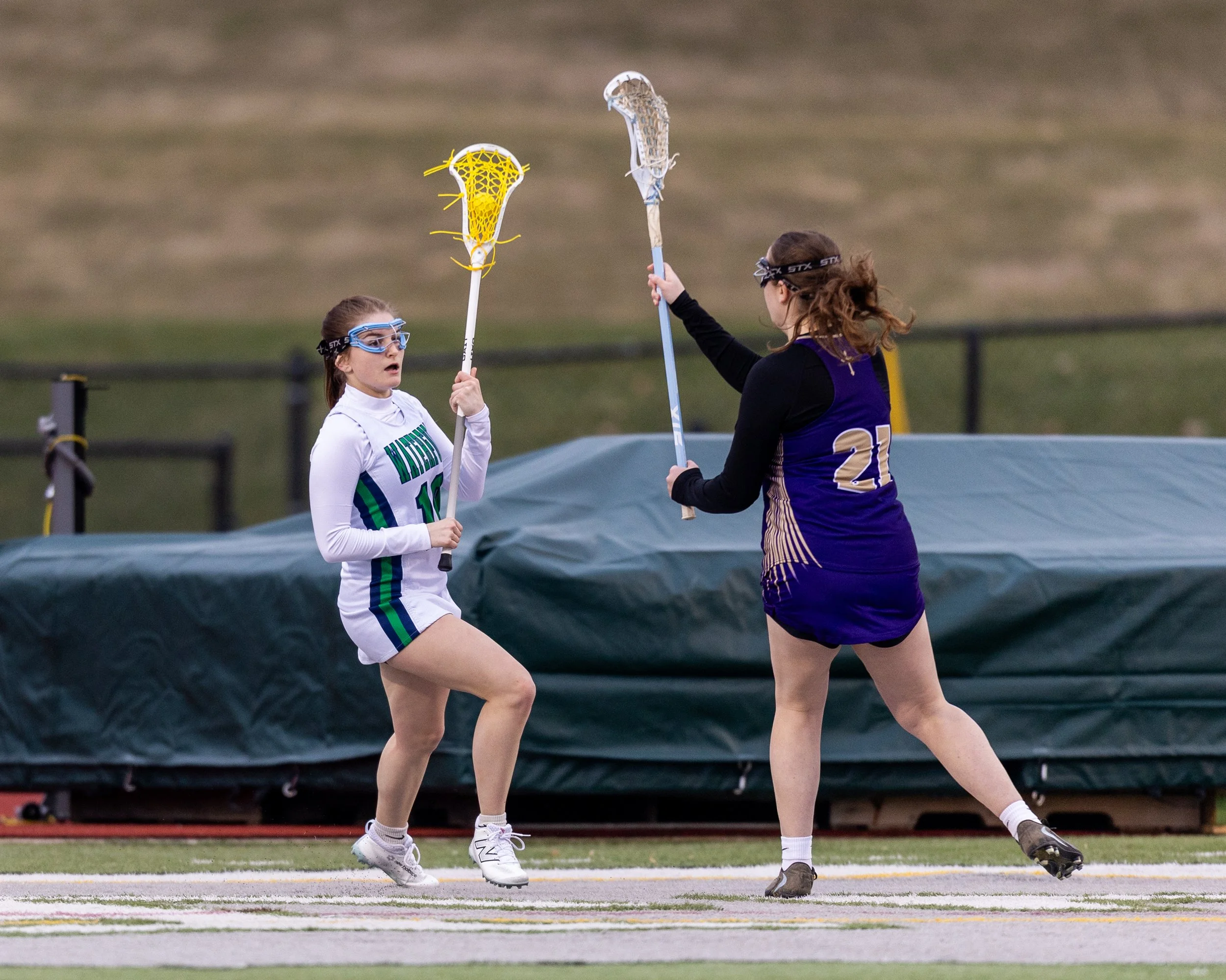 #10 carries the ball with a defender