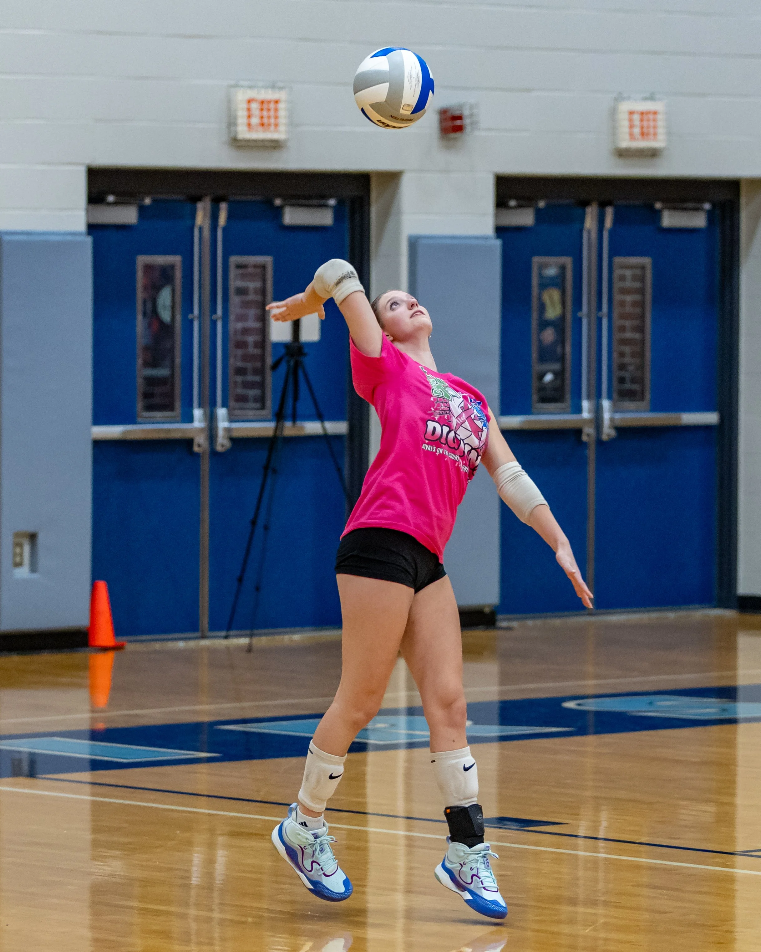 Kettering player serves the ball