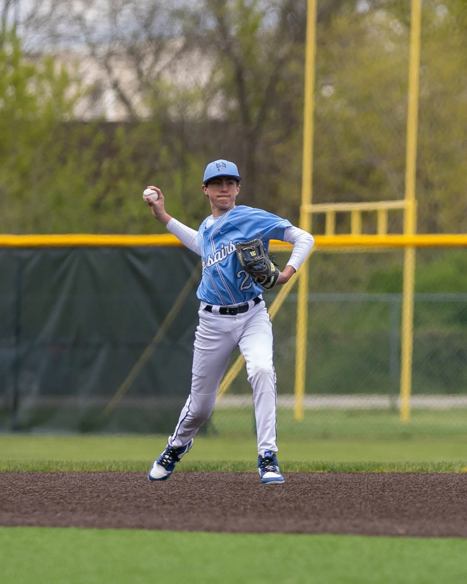 Mott shortstop throws the ball to 1st base