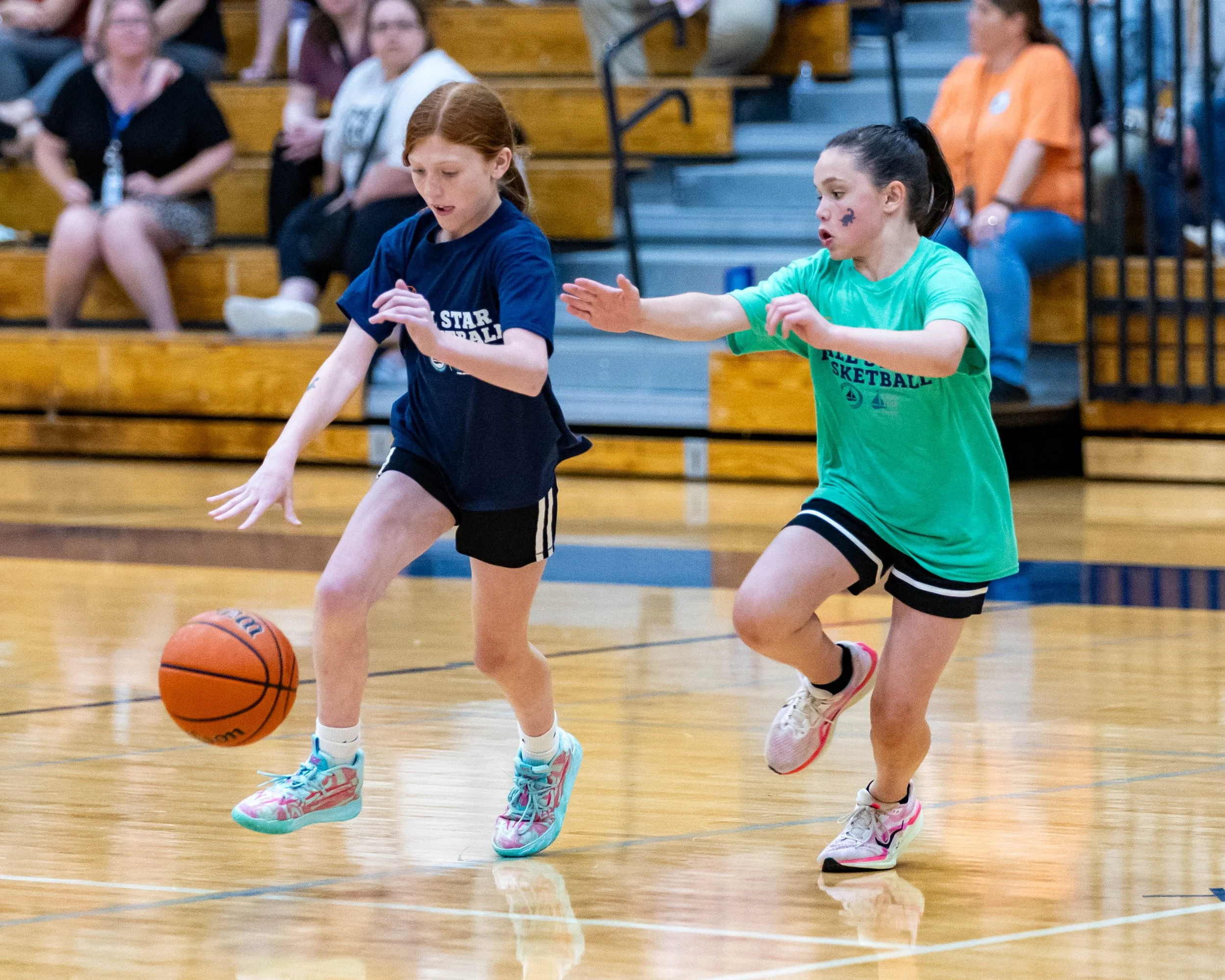 North girl dribbles the ball around am South girl