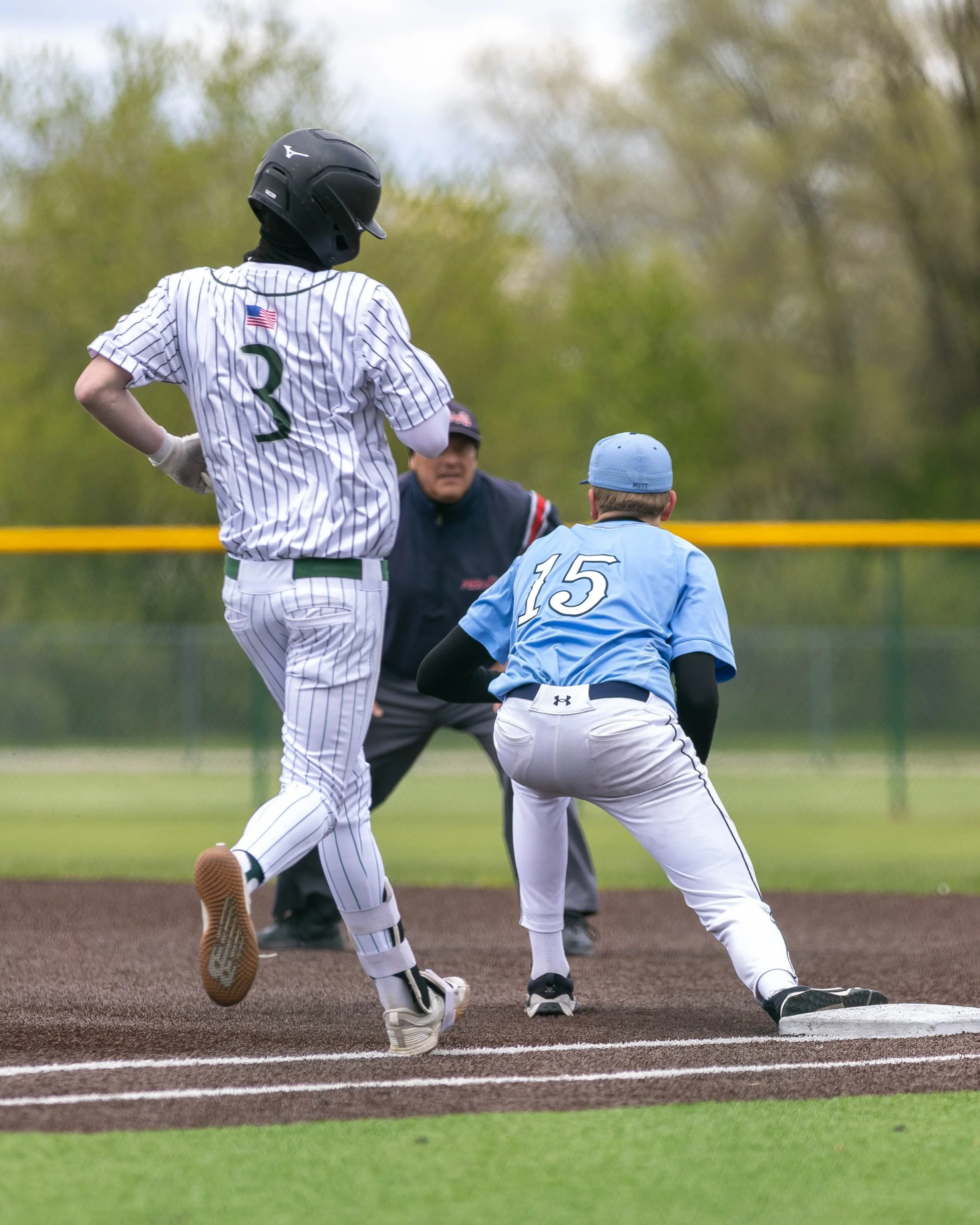 Mott #15 catches the ball at 1st base
