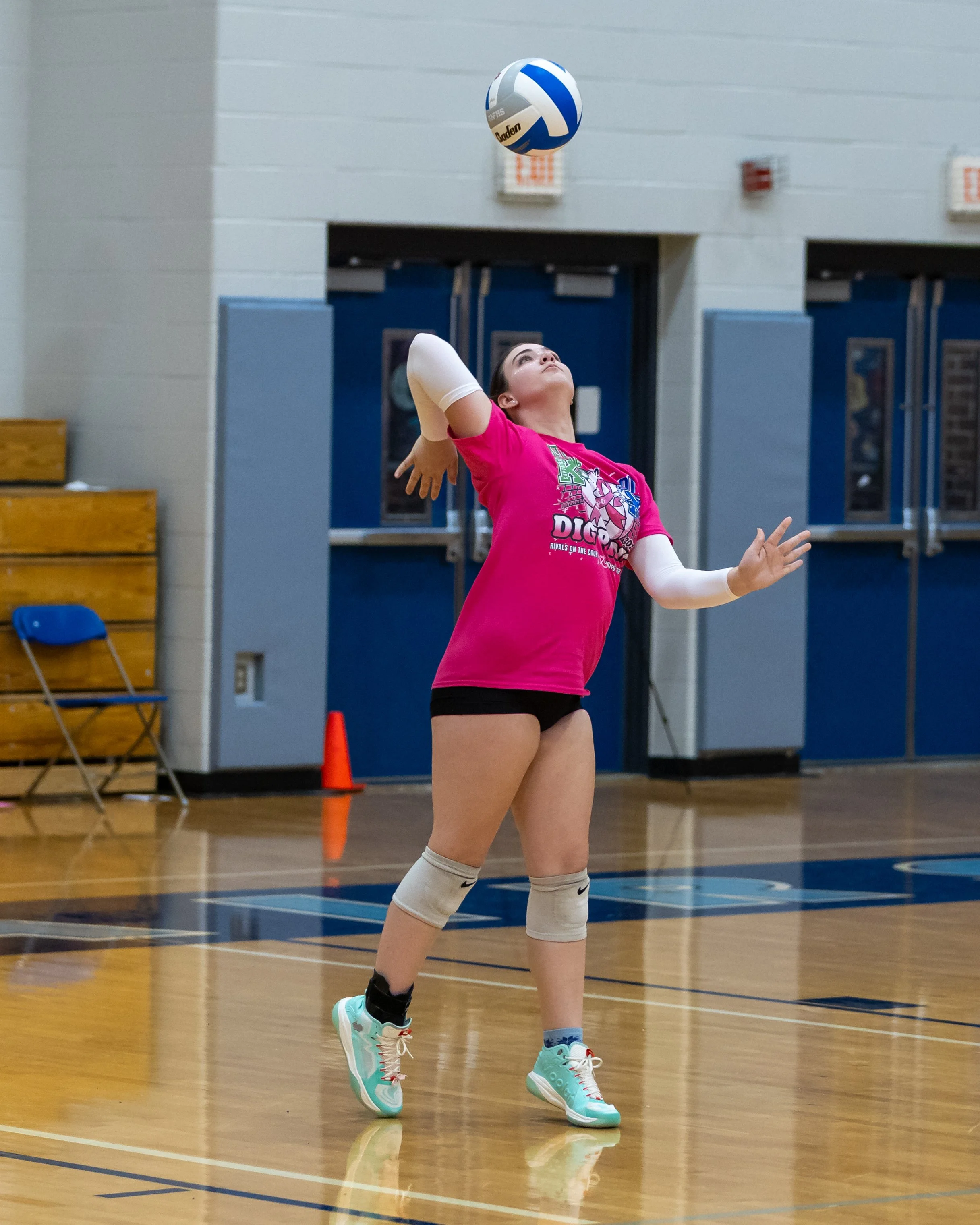Kettering player serves the ball