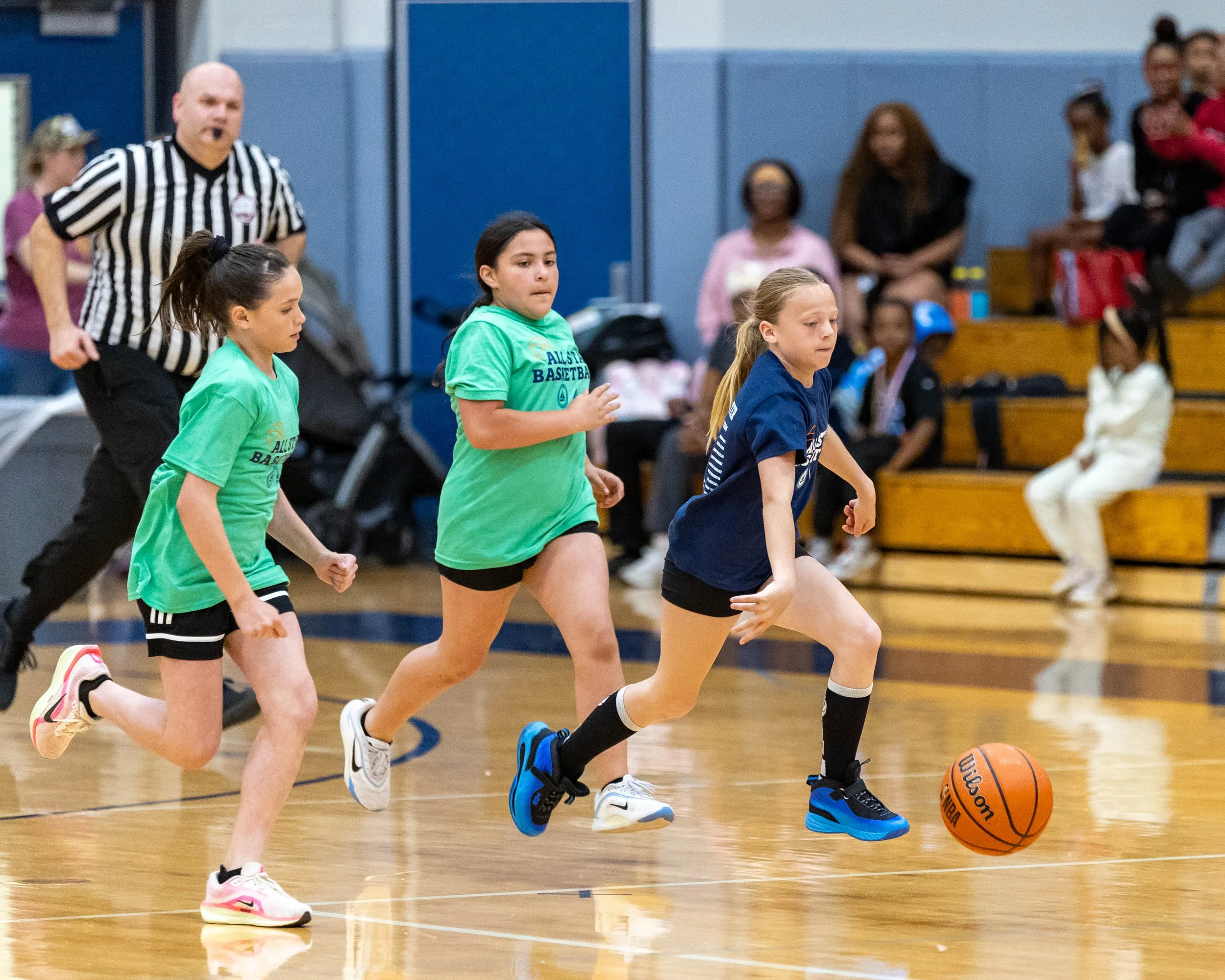 North girl dribbles the ball