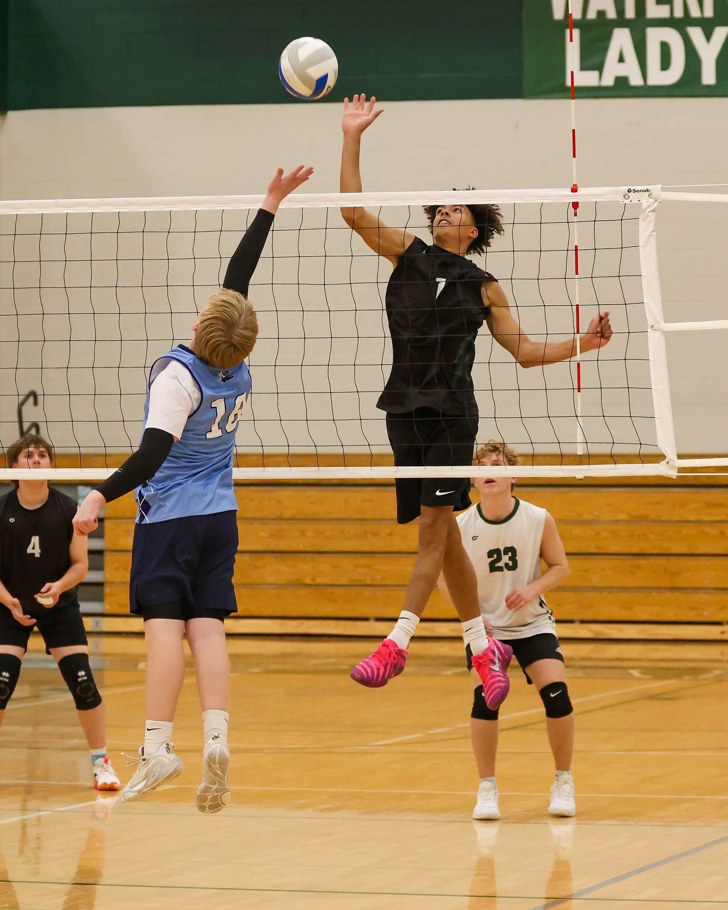 Kettering #1 taps the ball over the net