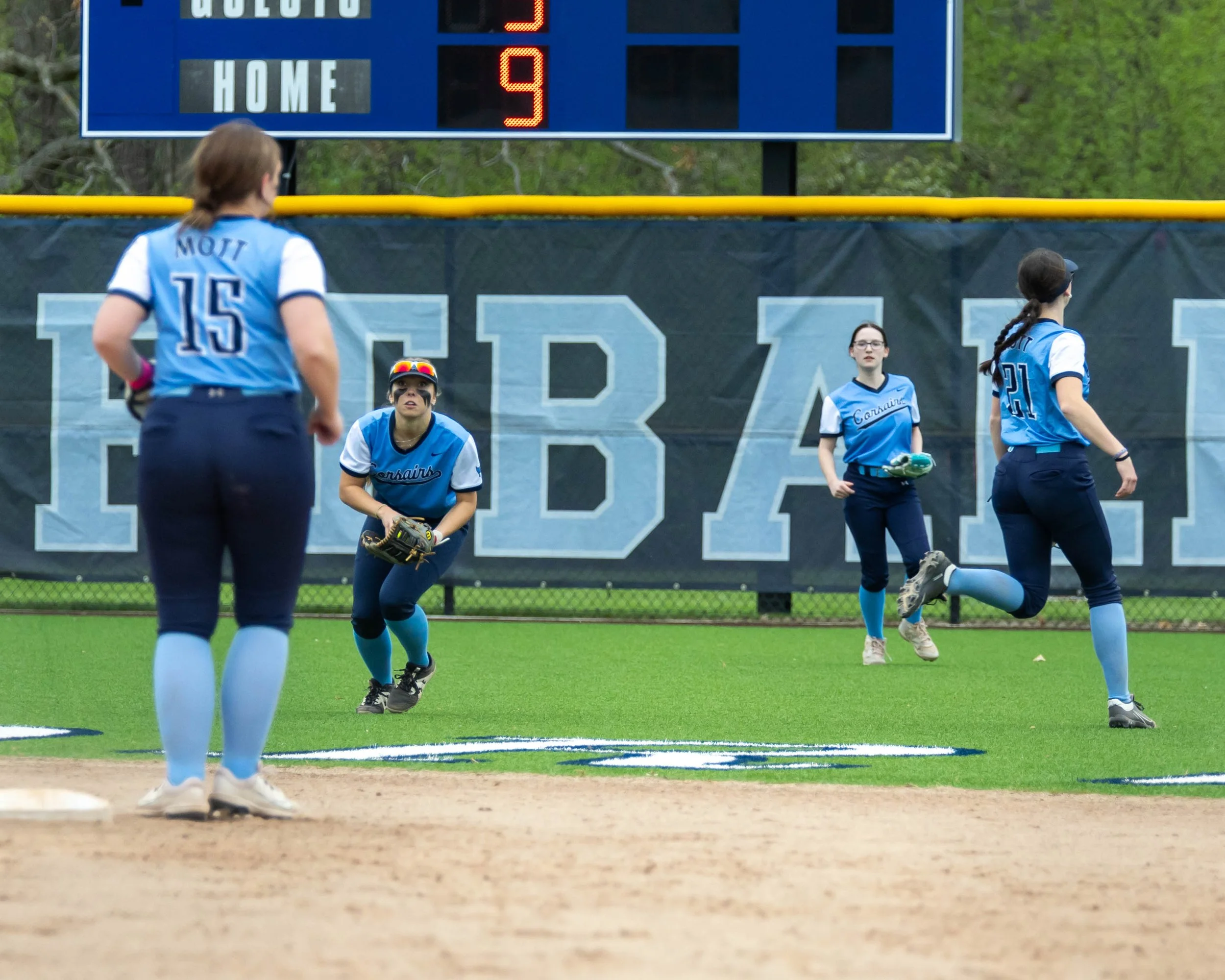 Mott center fielder scoops up the ball