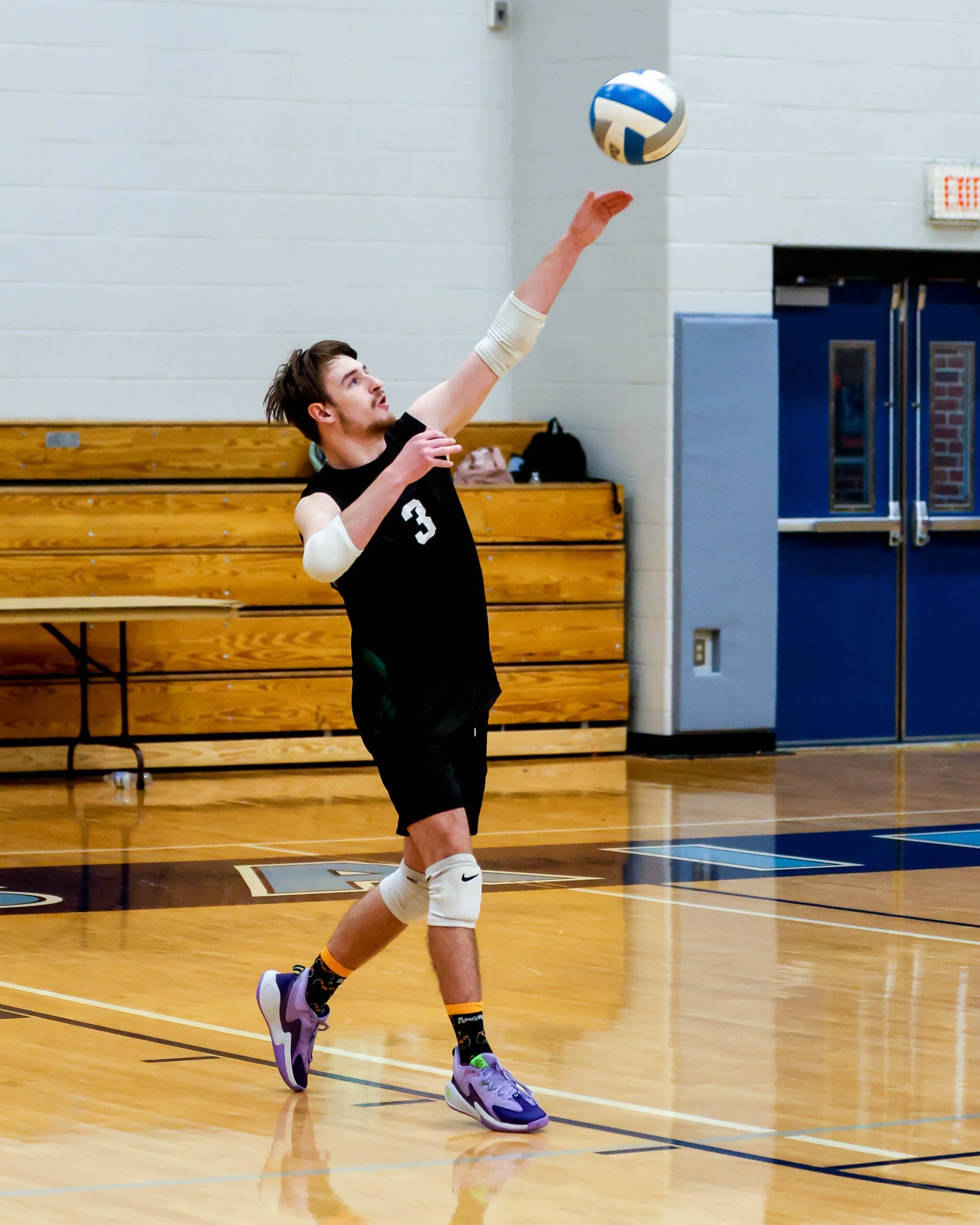 Kettering #3 serves the ball