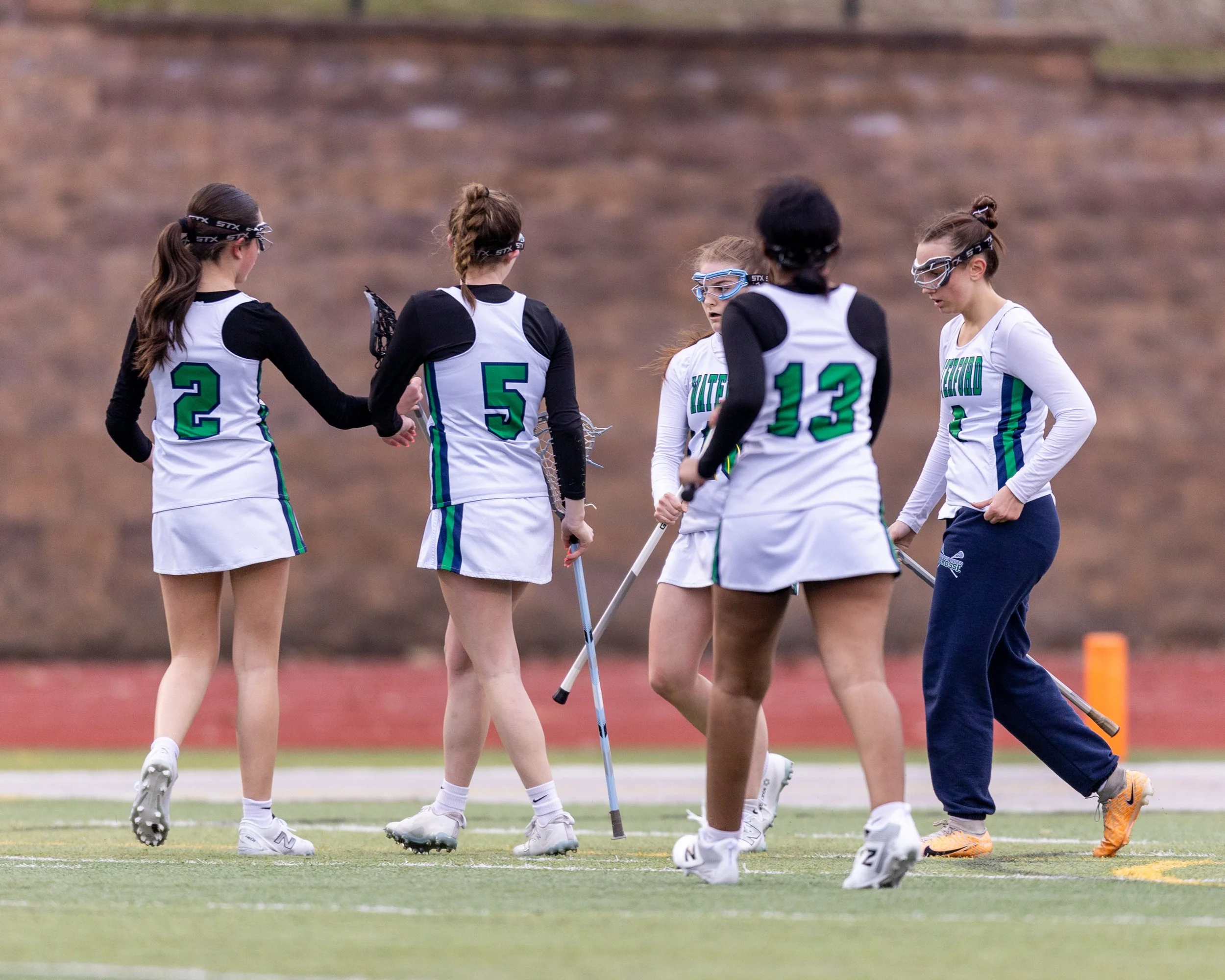 #10 scores and celebrates with her team