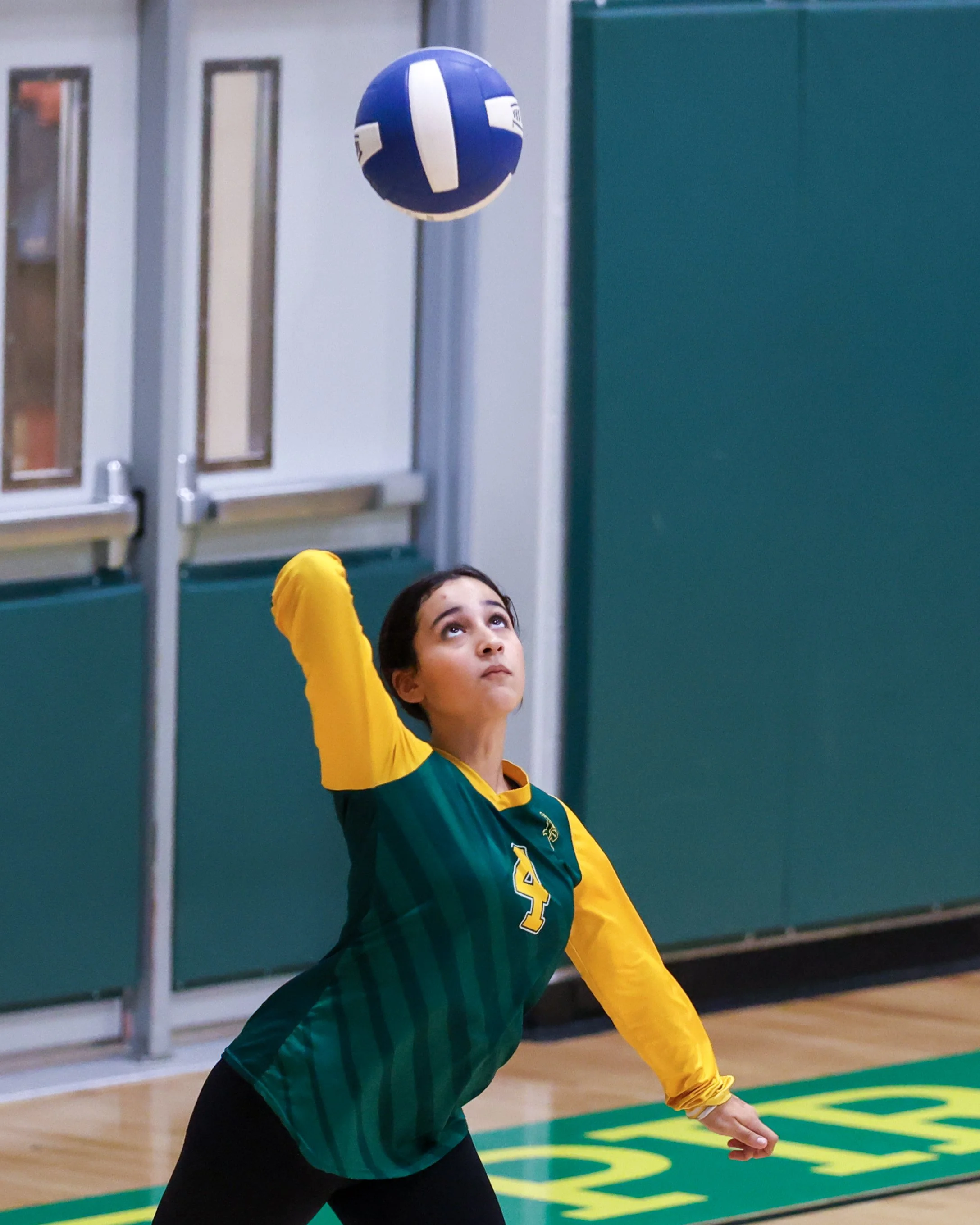 Pierce girl serves the ball