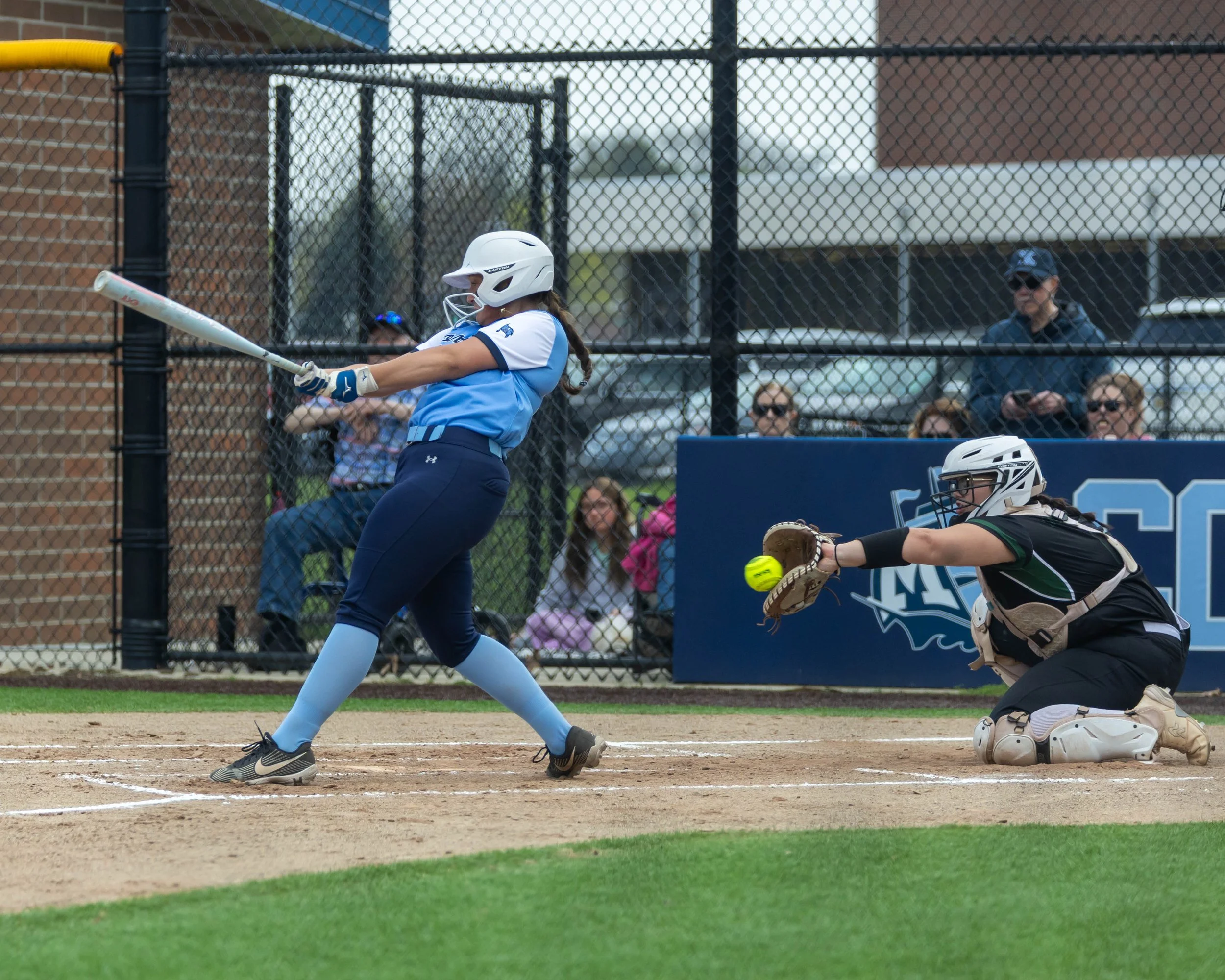 Mott #20 swings at a pitch caught by the Kettering catcher