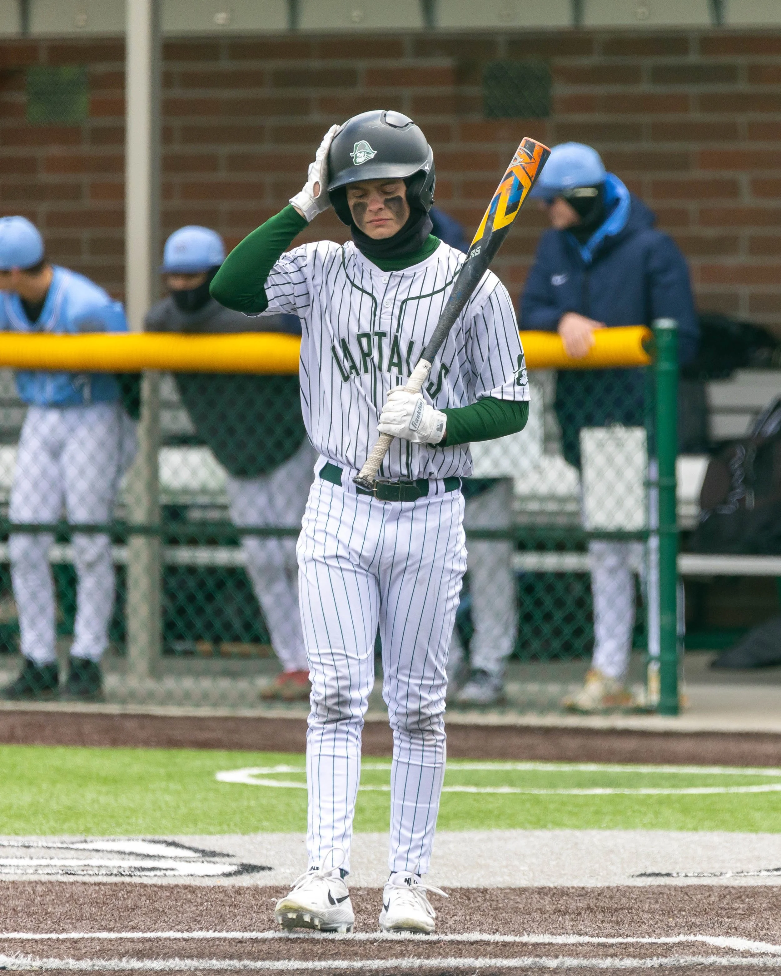 Kettering #6 gets the signals from 3rd base coach