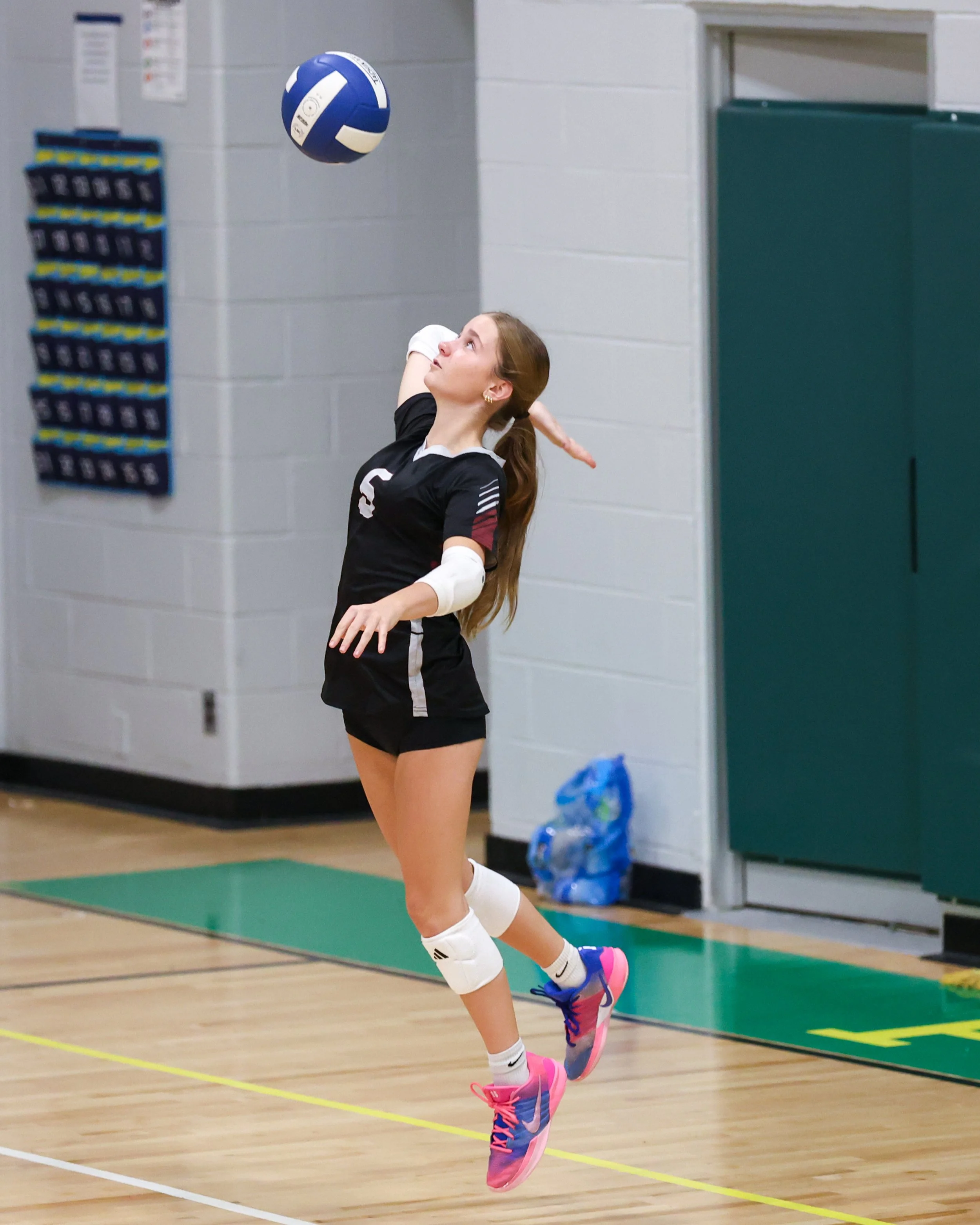 Mason girl serves the ball