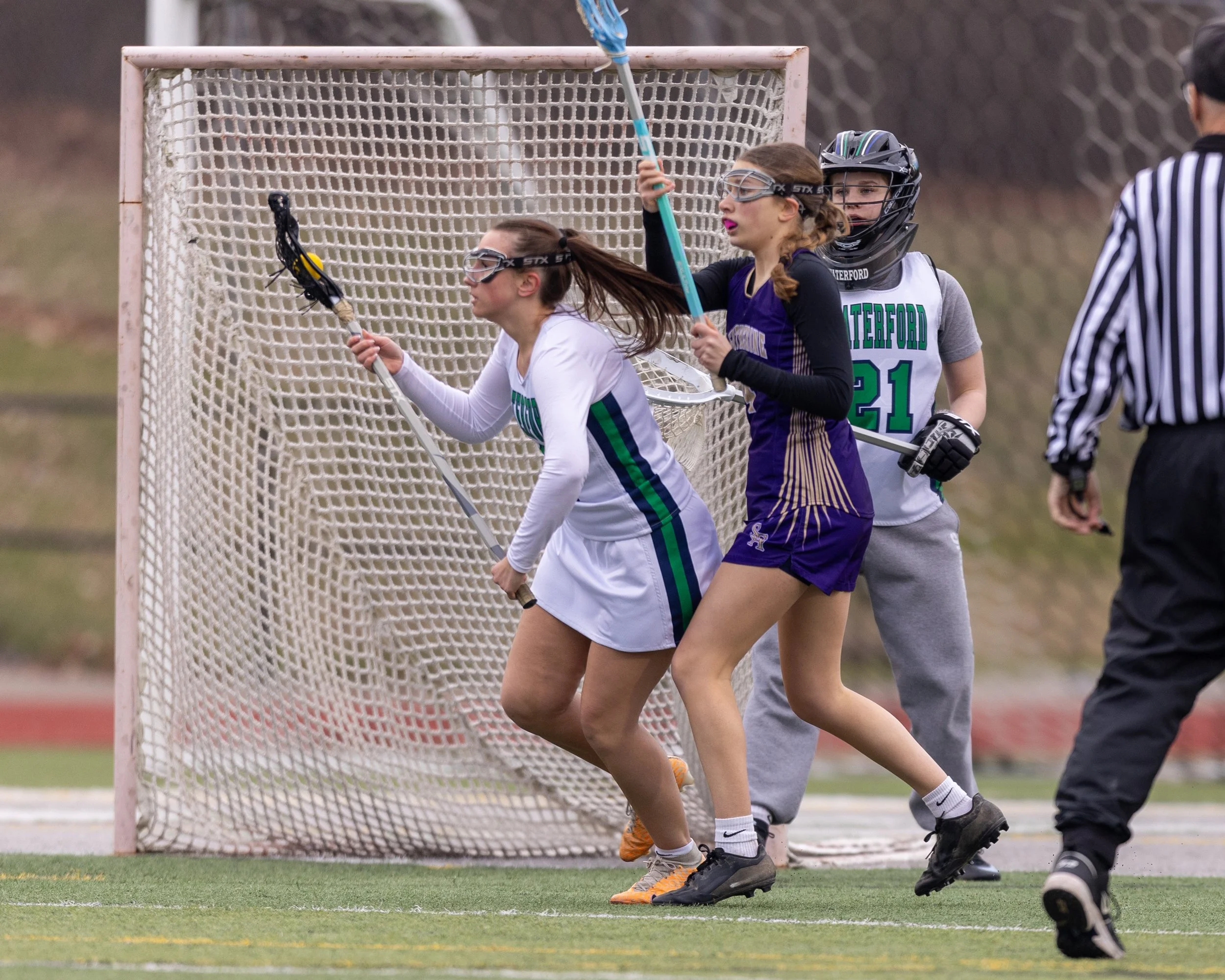 #3 carries the ball past a defender