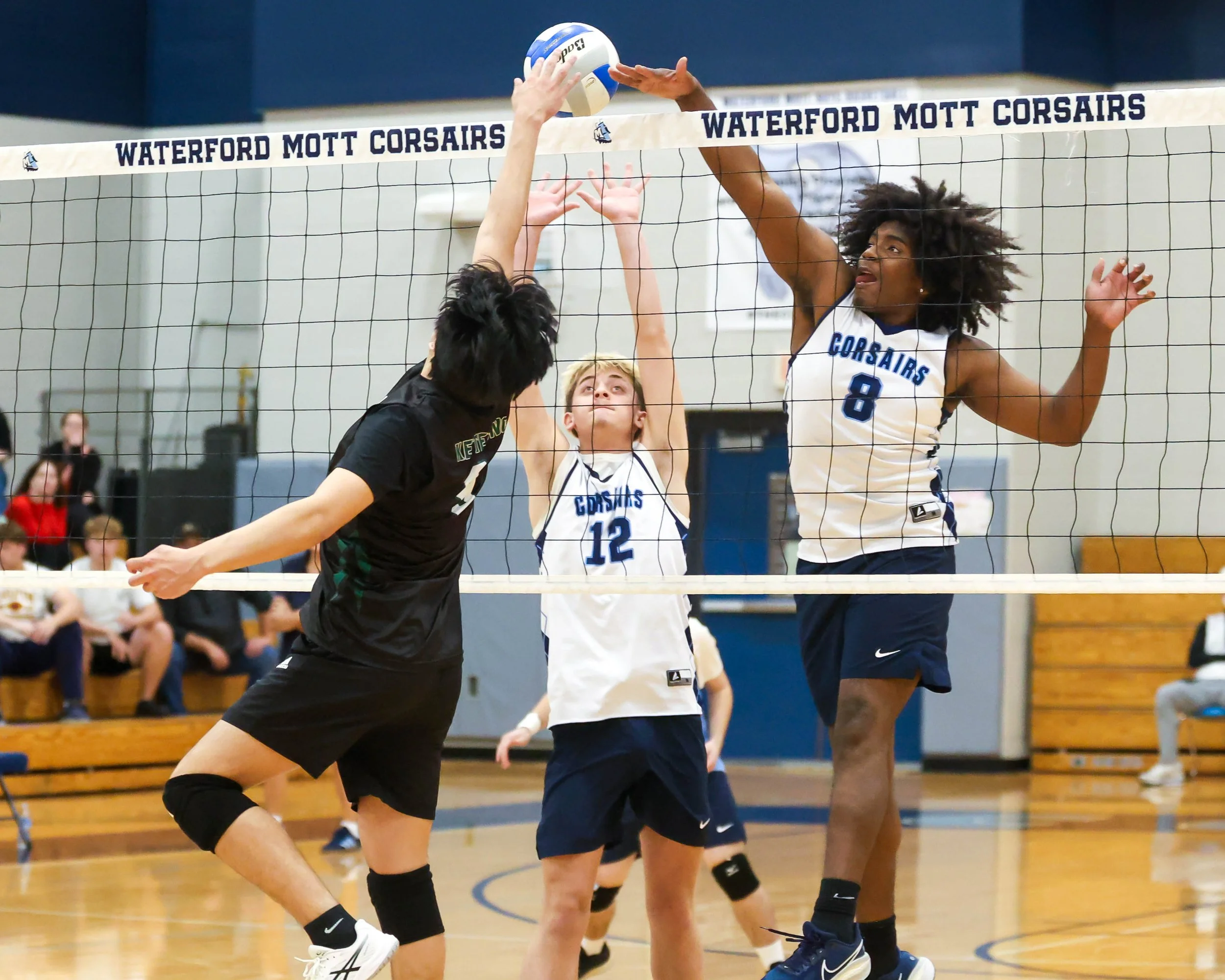 Kettering #6 tips the ball and Mott# 12 and #8 try to block it