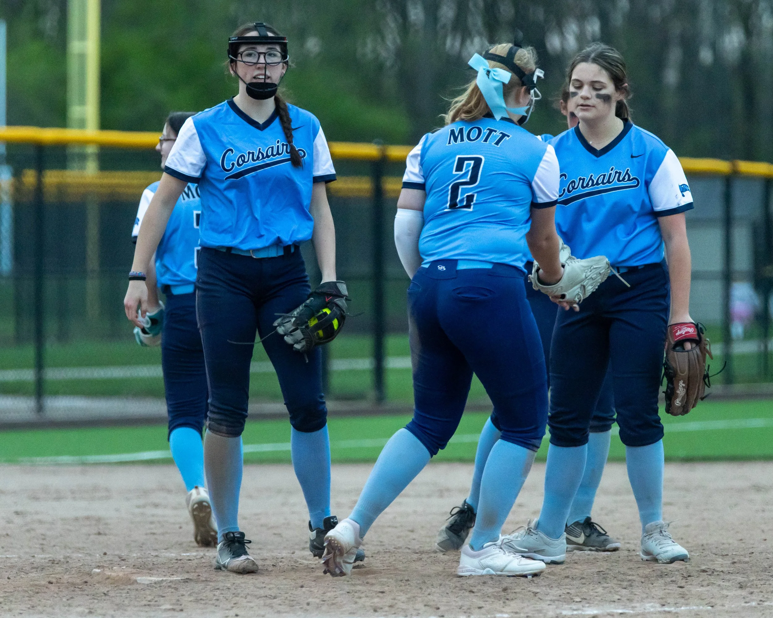 Mott infielders celebrate a strikeout 