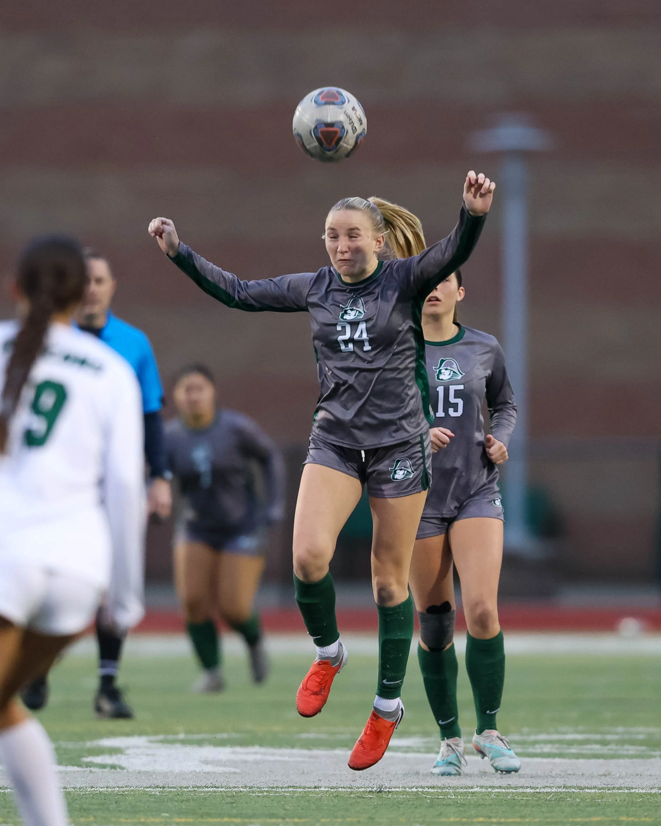 #24 heads the ball
