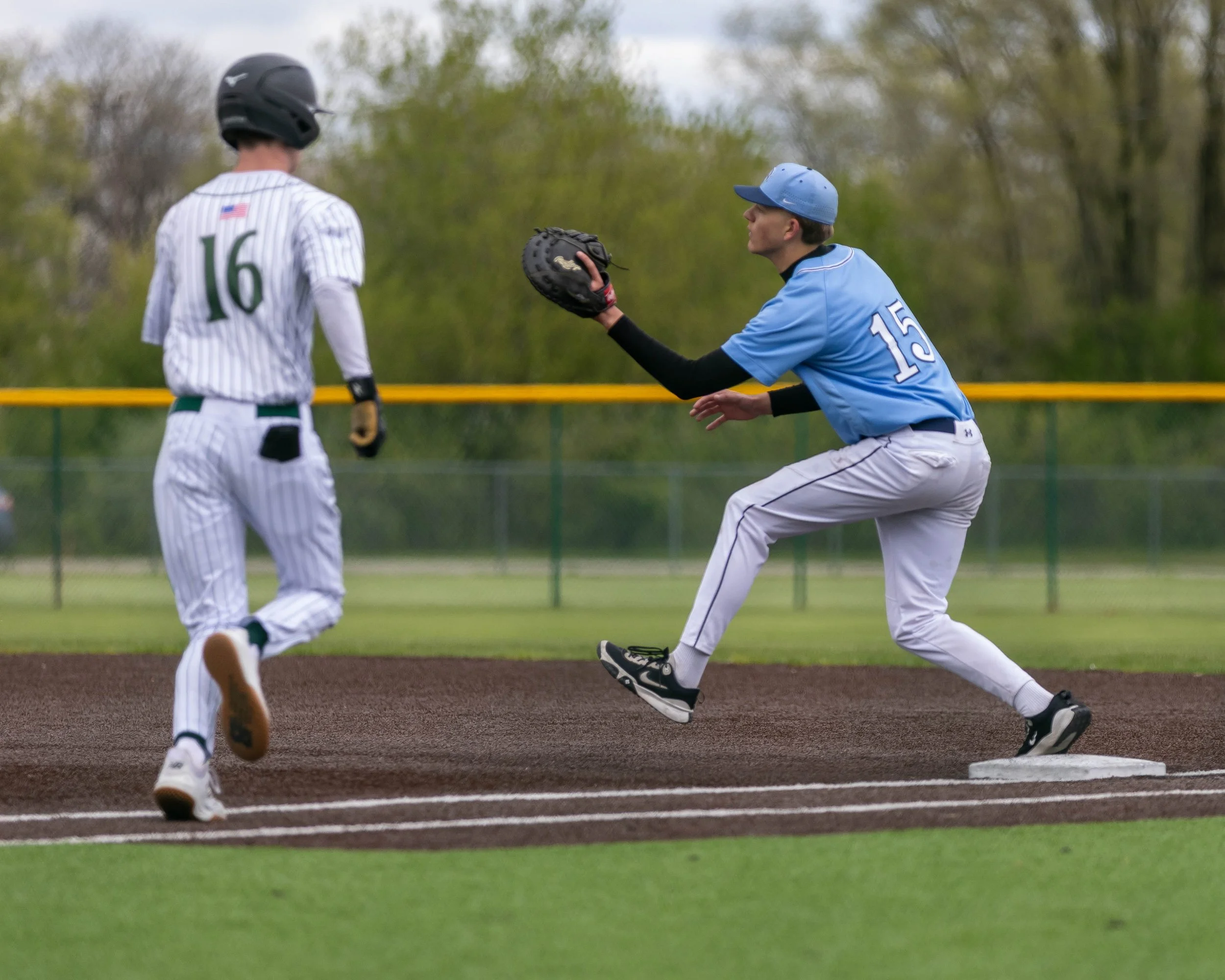 Mott #15 catches the ball at 1st base