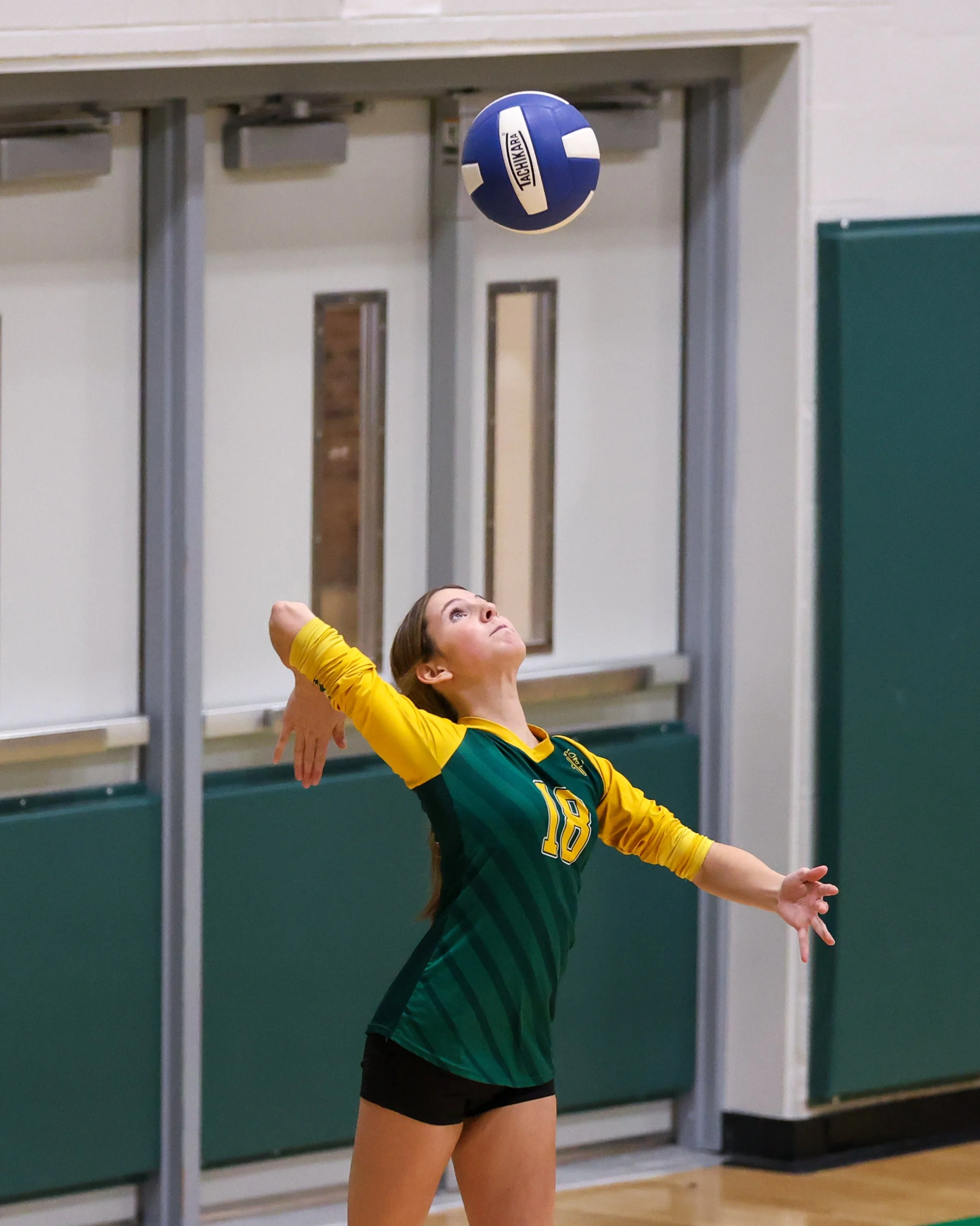 Pierce girl serves the ball