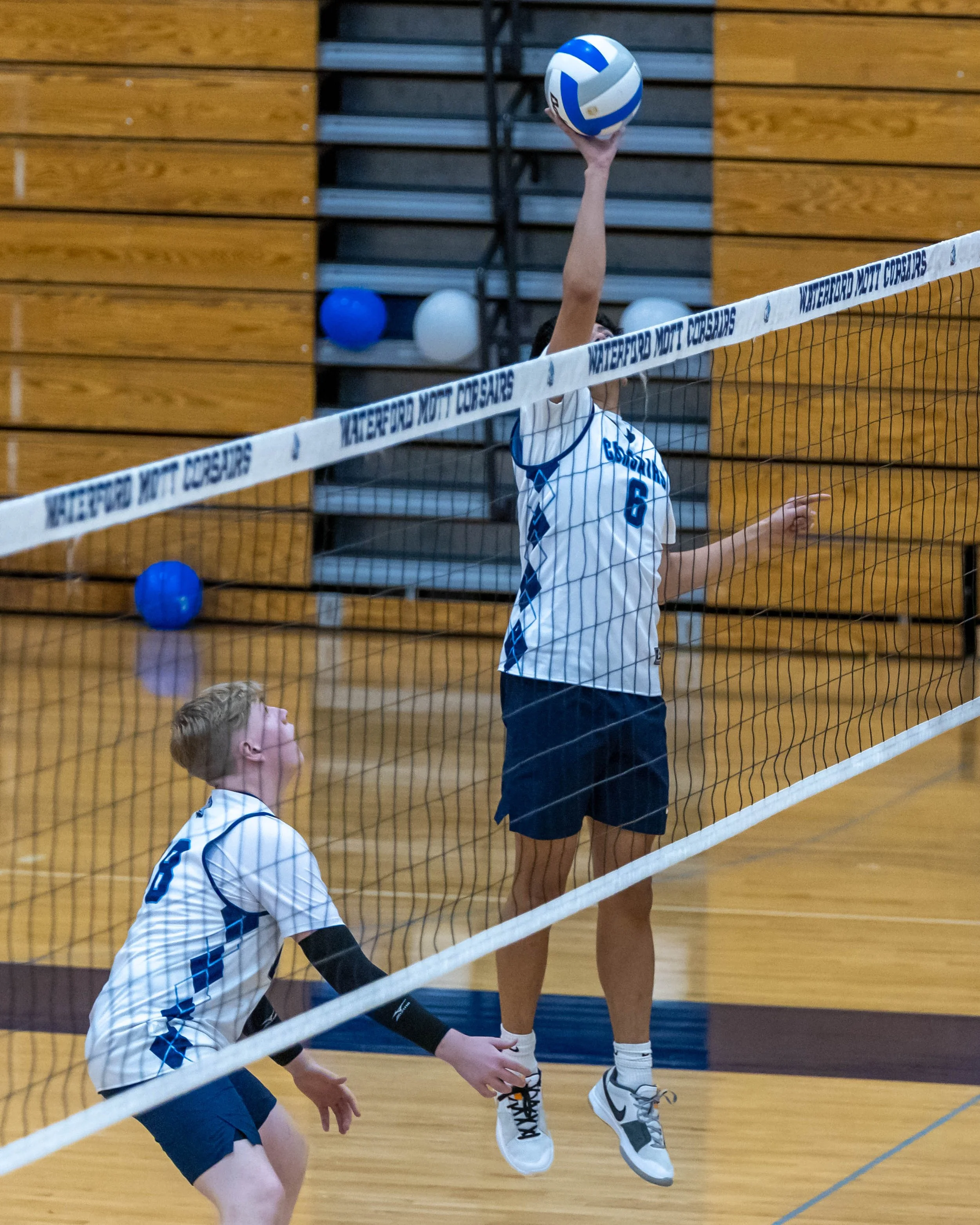 #6 hits the ball over the net