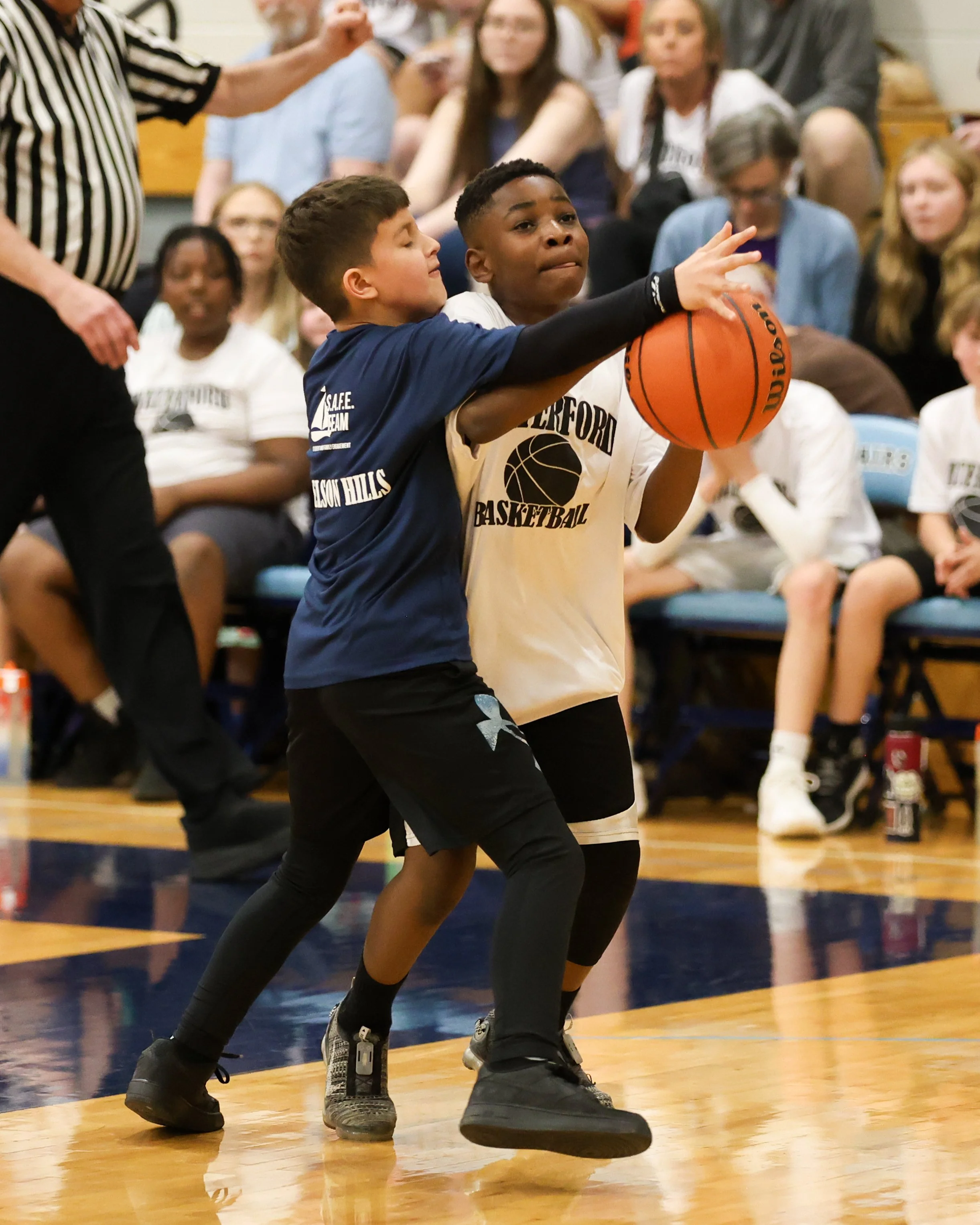 Beaumont boy shoots the ball guarded by Donelson Hills boy