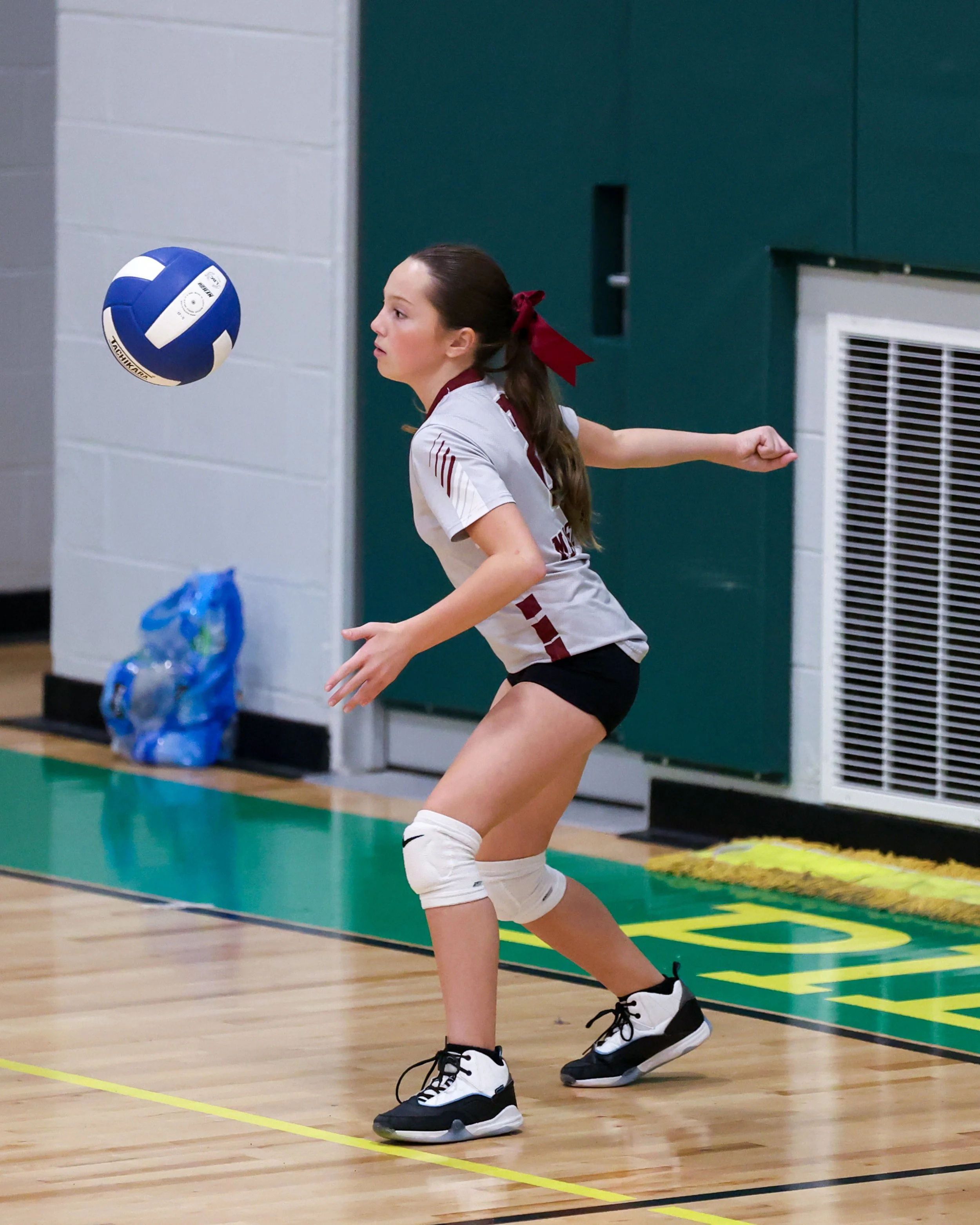 Mason girl serves the ball