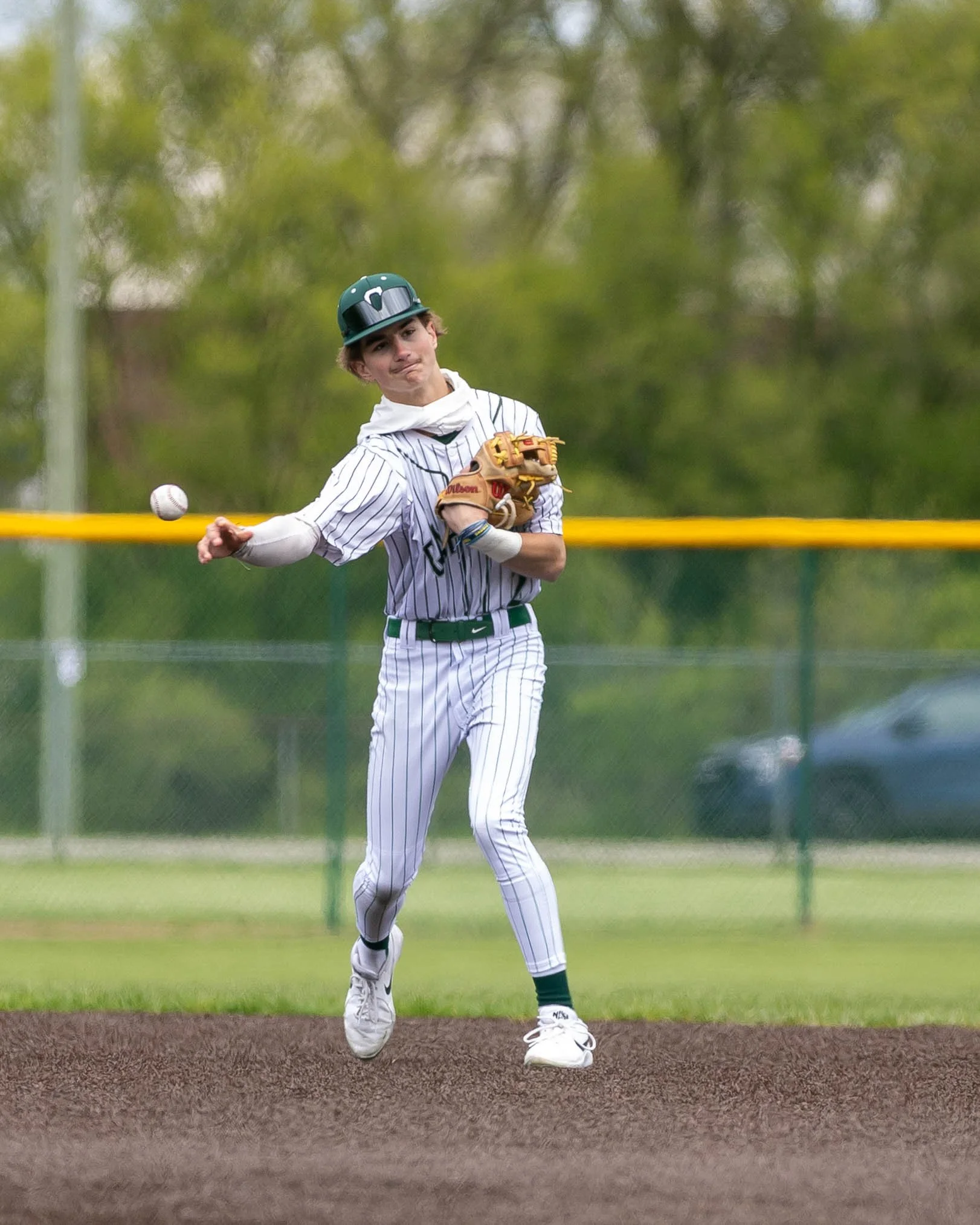 Kettering #2 throws the ball to 1st base
