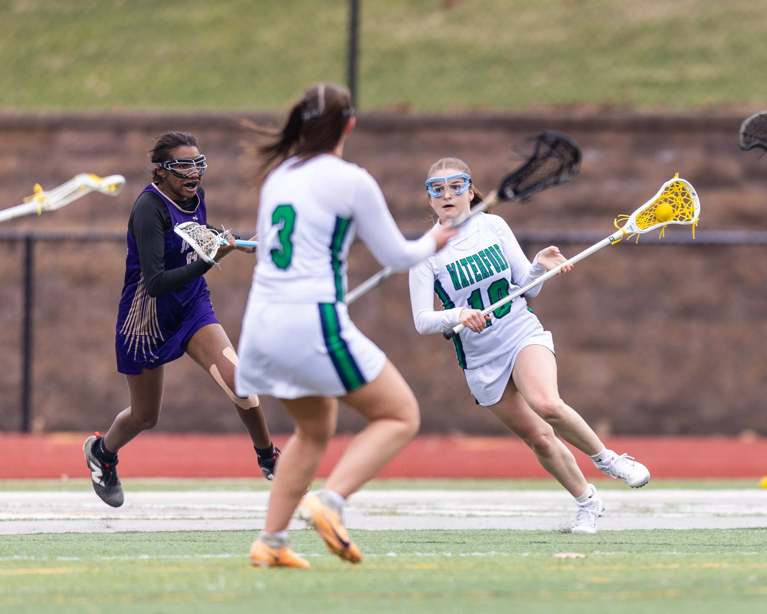#10 crosses the field with the ball