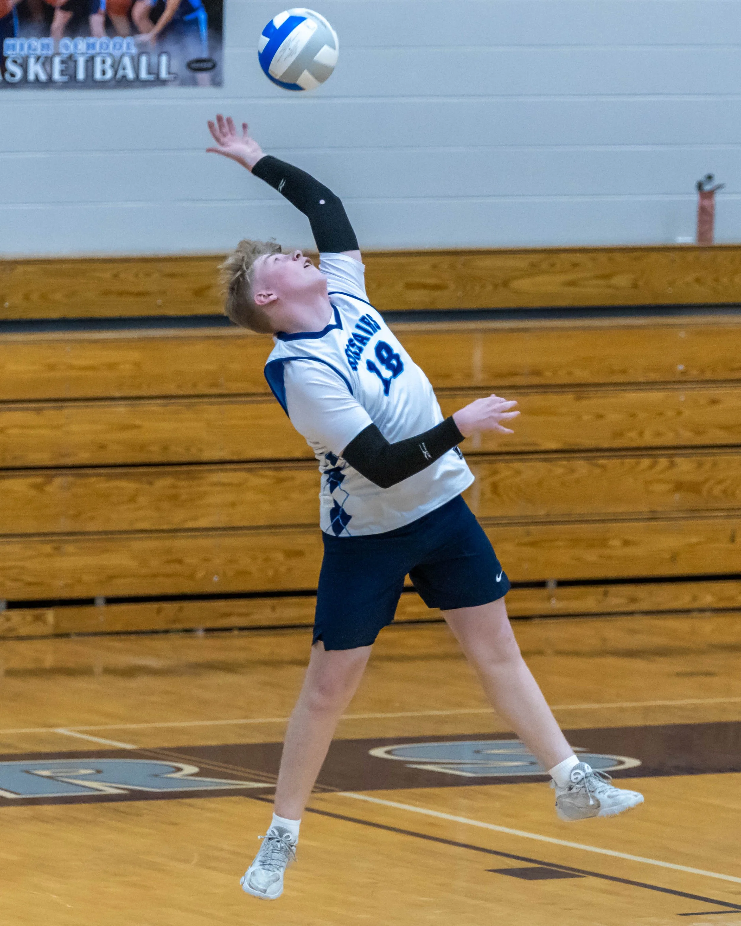 #18 serves the ball