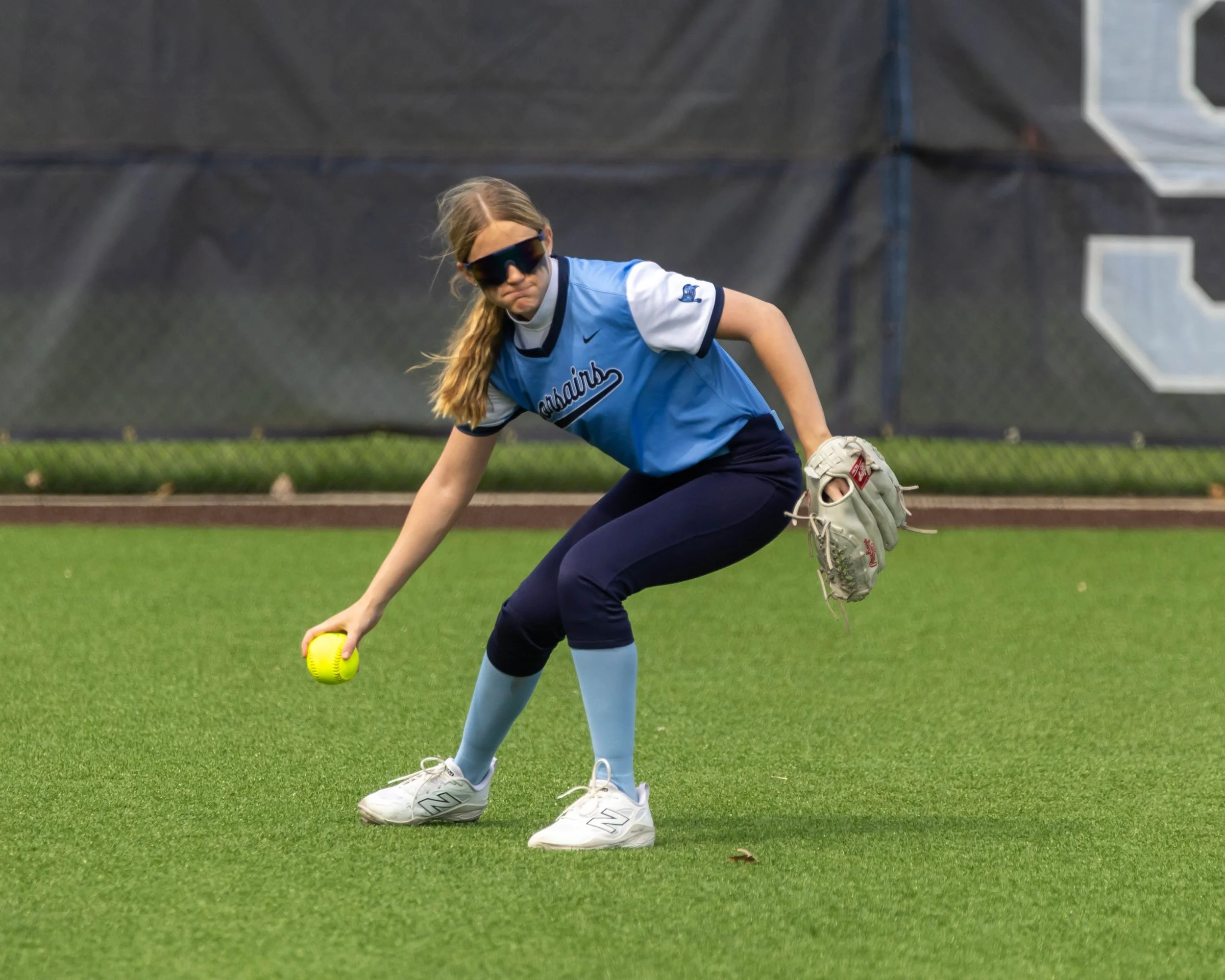 Mott player picks up the ball in the outfield