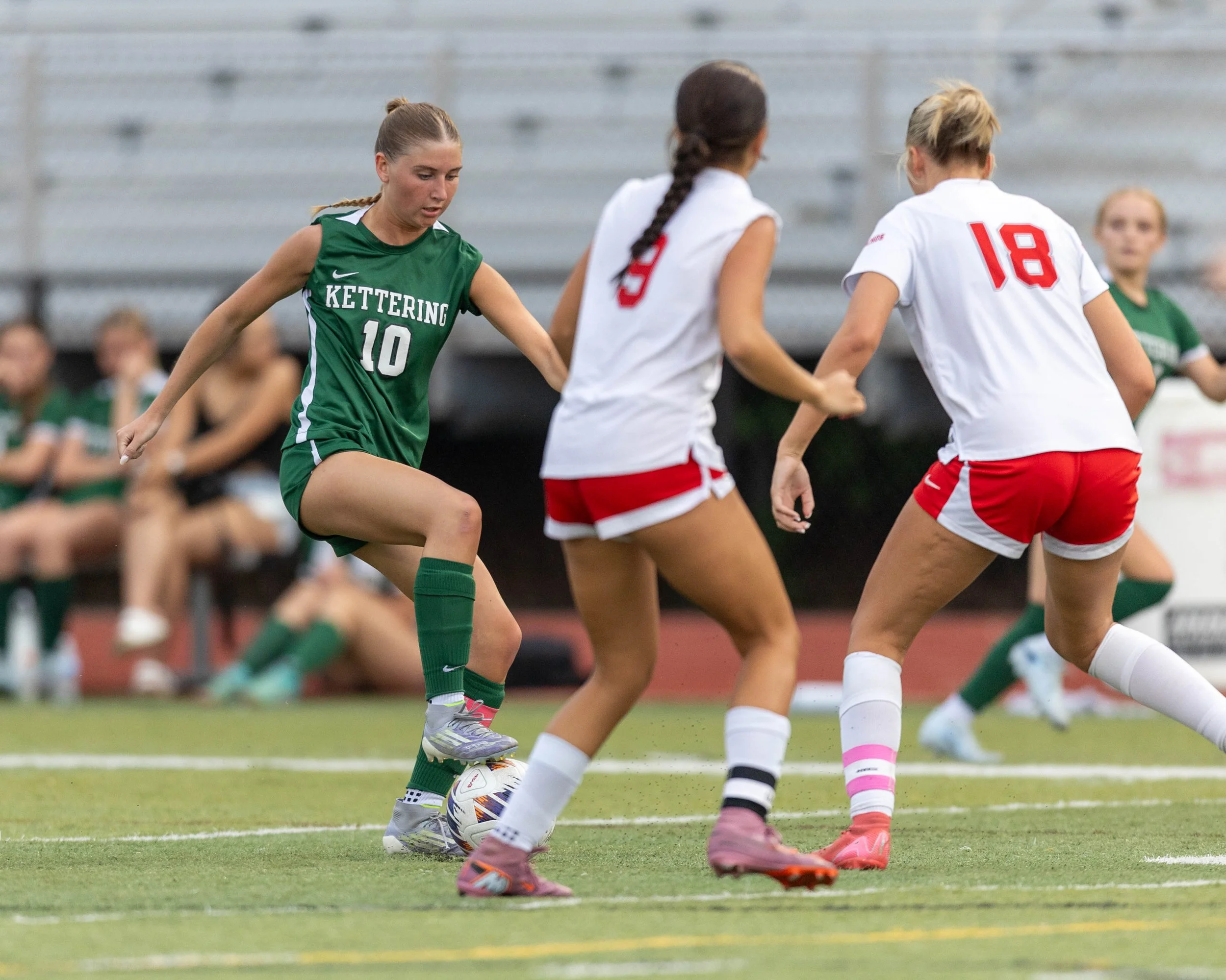 #10 dribbles the ball towards two defenders