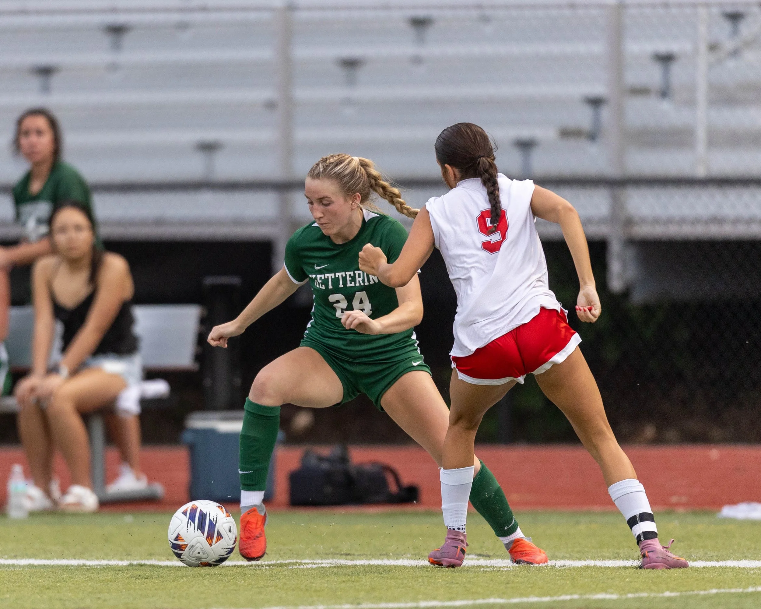 #24 dribbles the ball past a defender