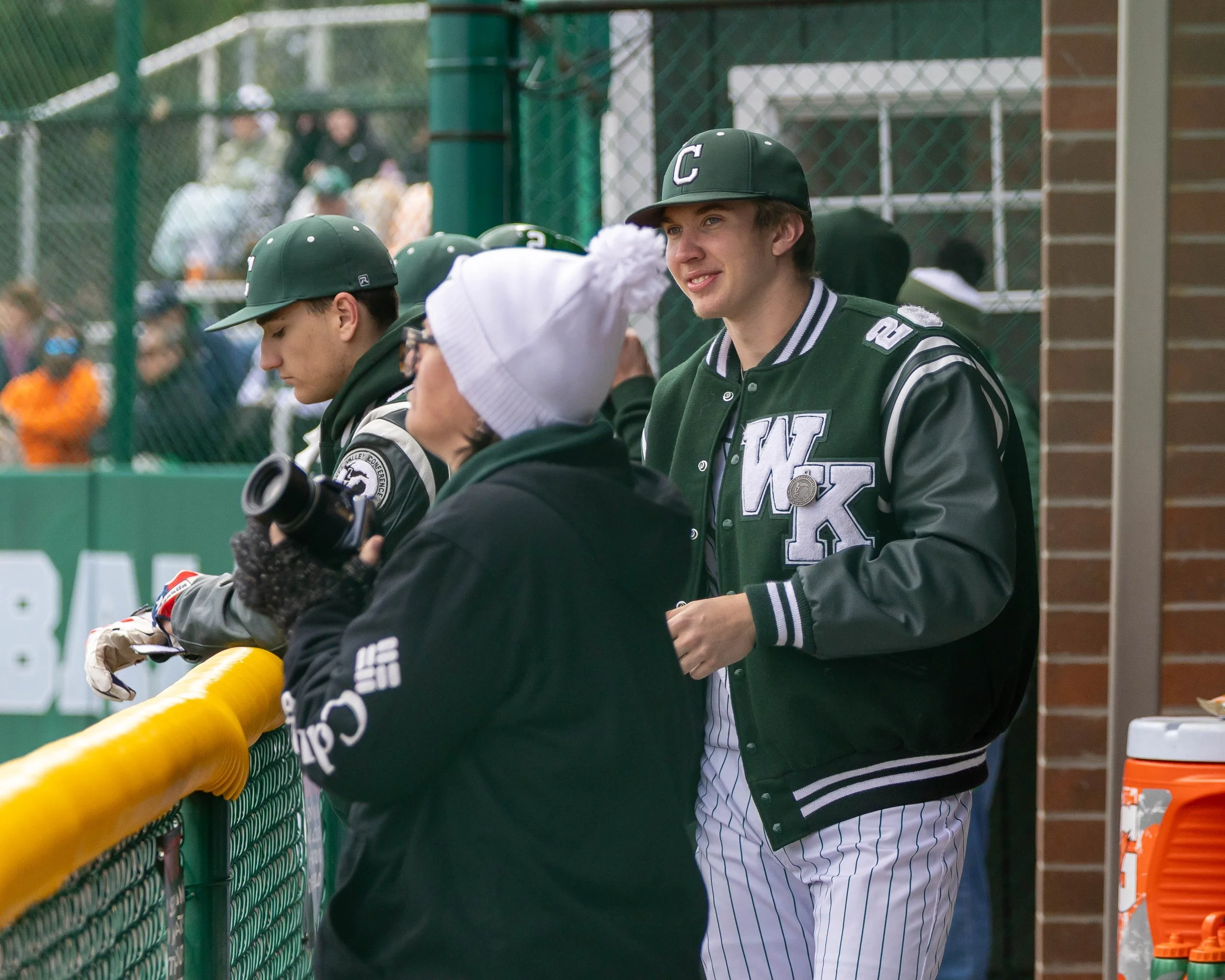 Kettering #18 celebrates in the dugout