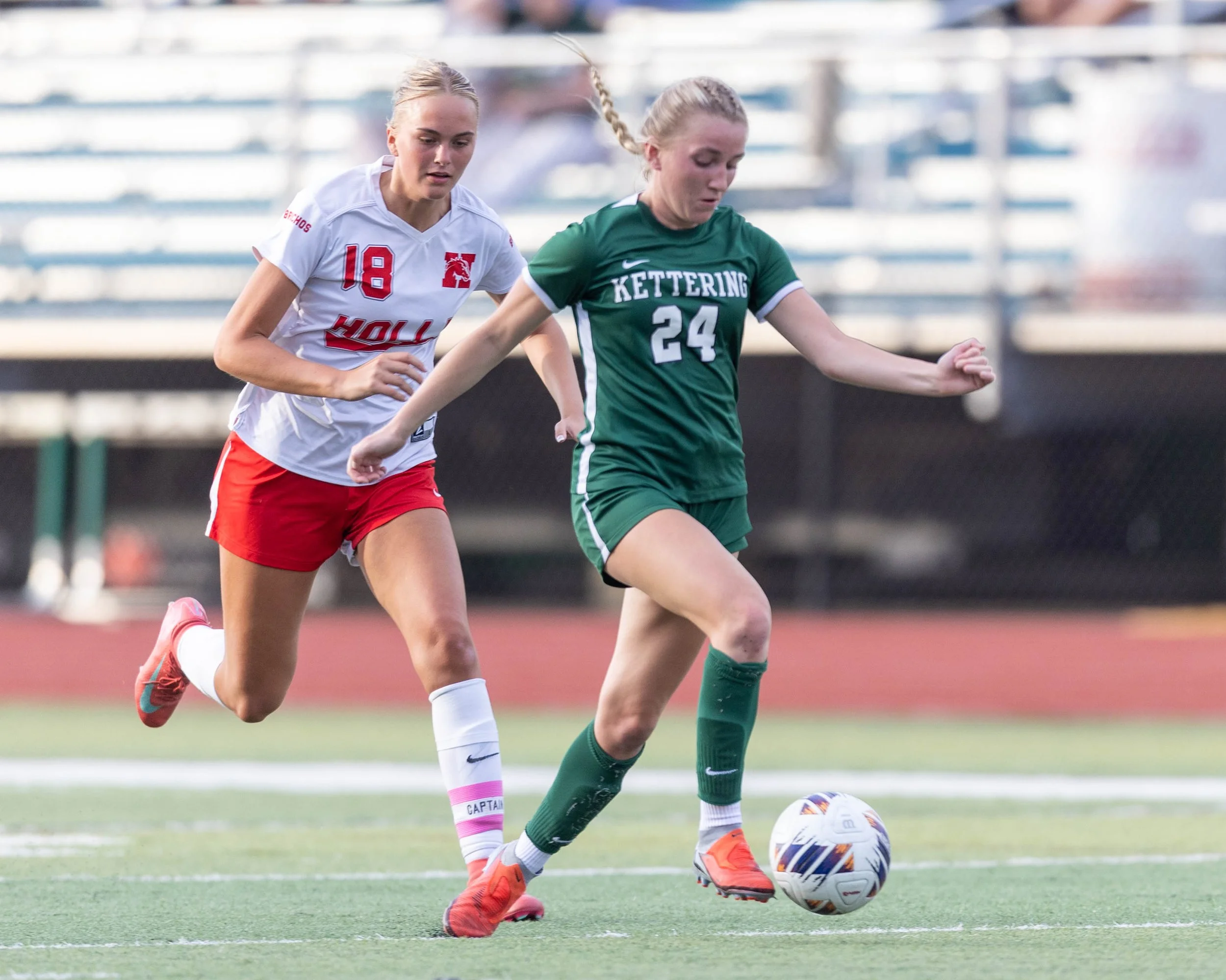 #24 kicks the ball with her toe