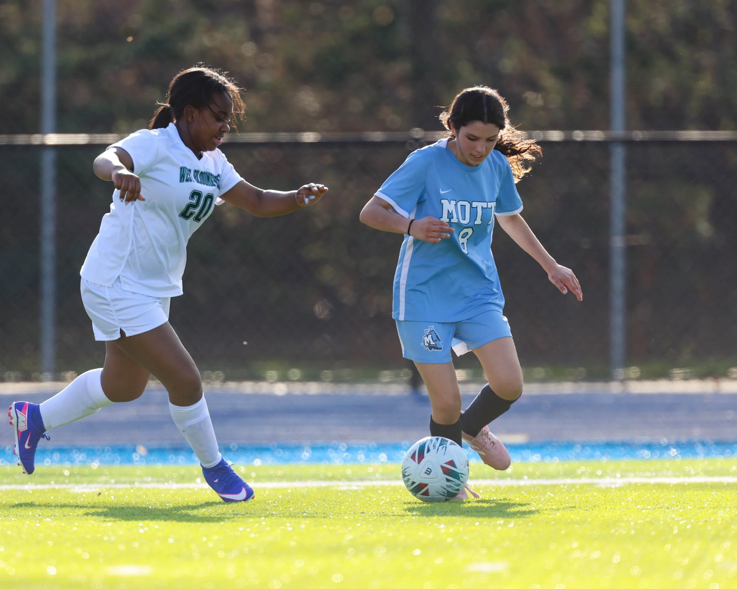 #8 dribbles the ball passed a defender