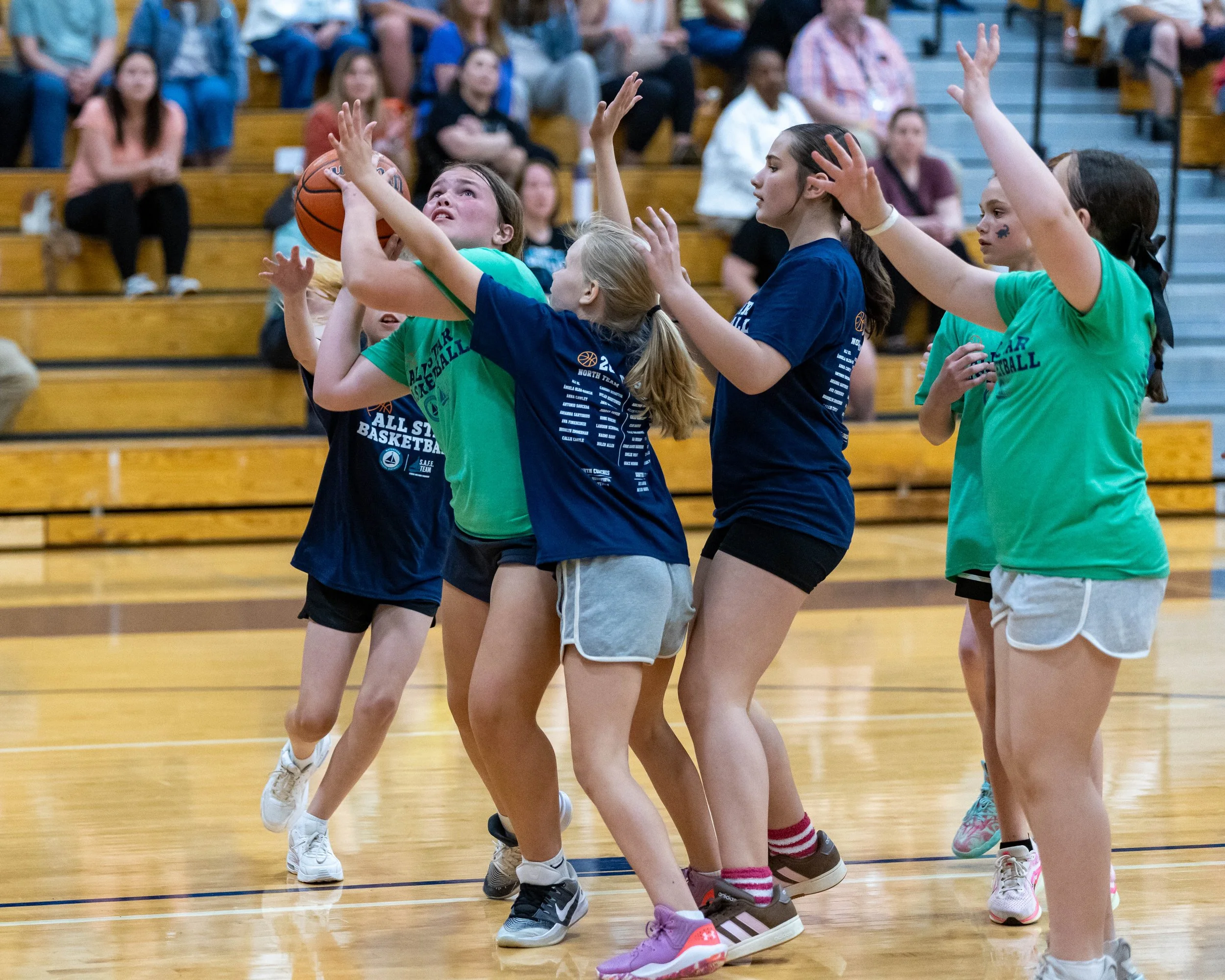 South girl shoots the ball surrounded by North girls