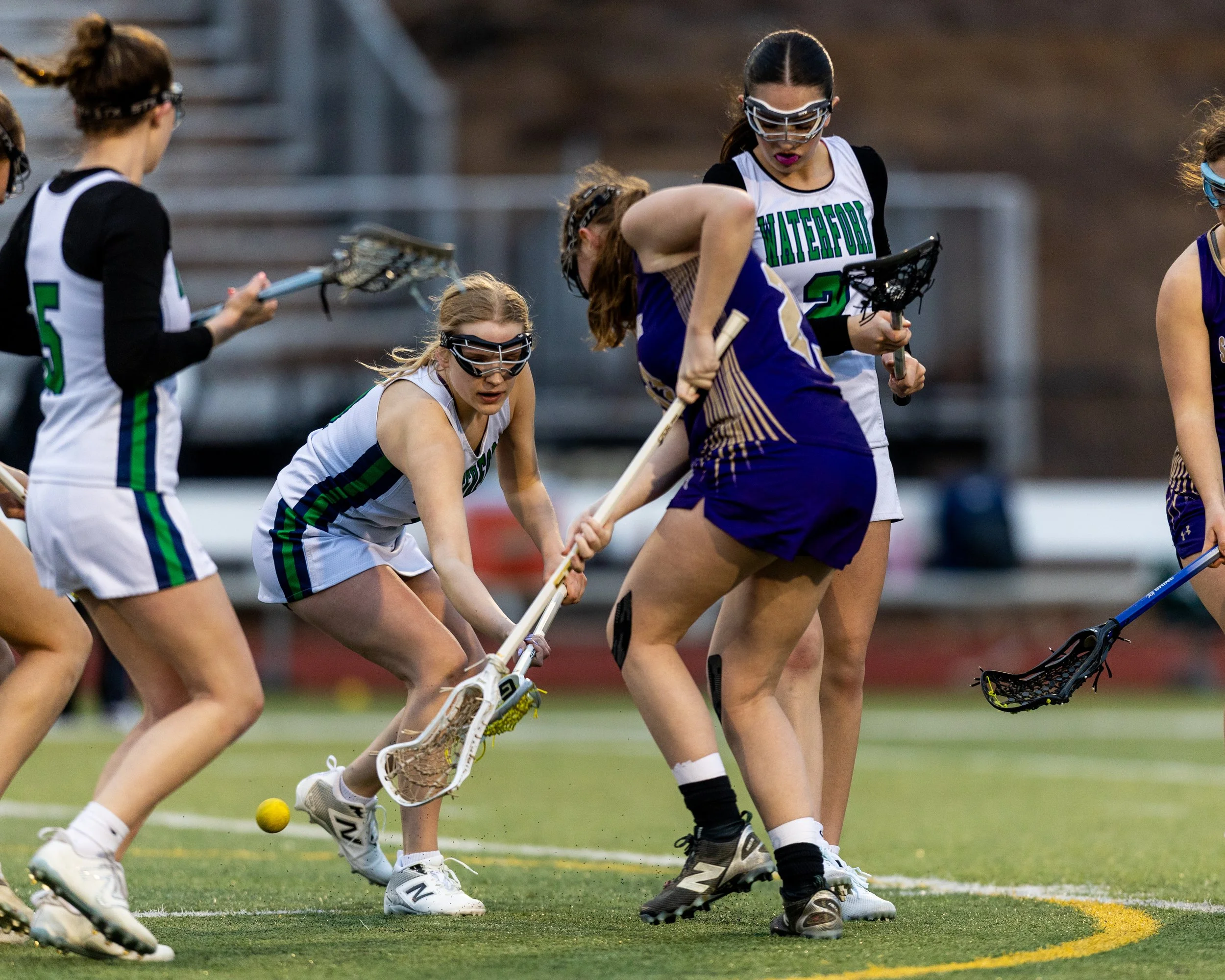 #9 fights for the ball with a St. Catherine's player