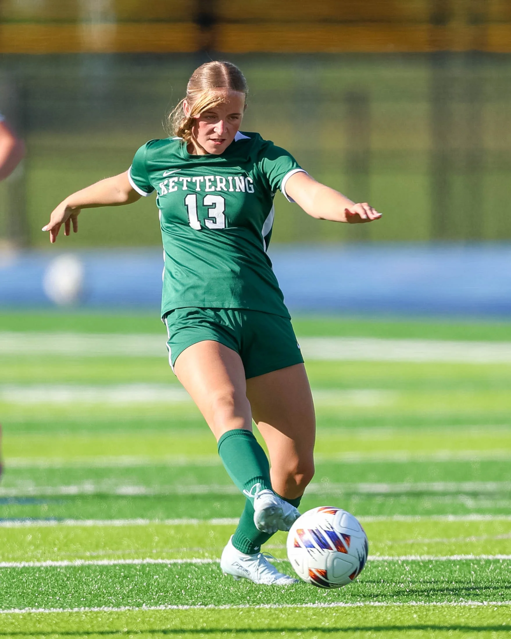 #13 controls the ball with her foot