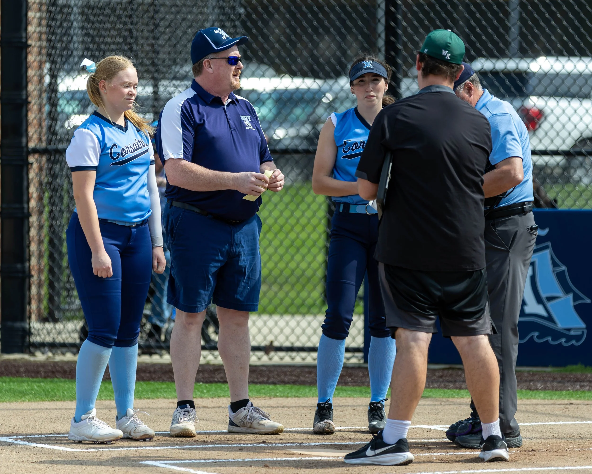 Coaches and Mott players pre-game meeting with umpires