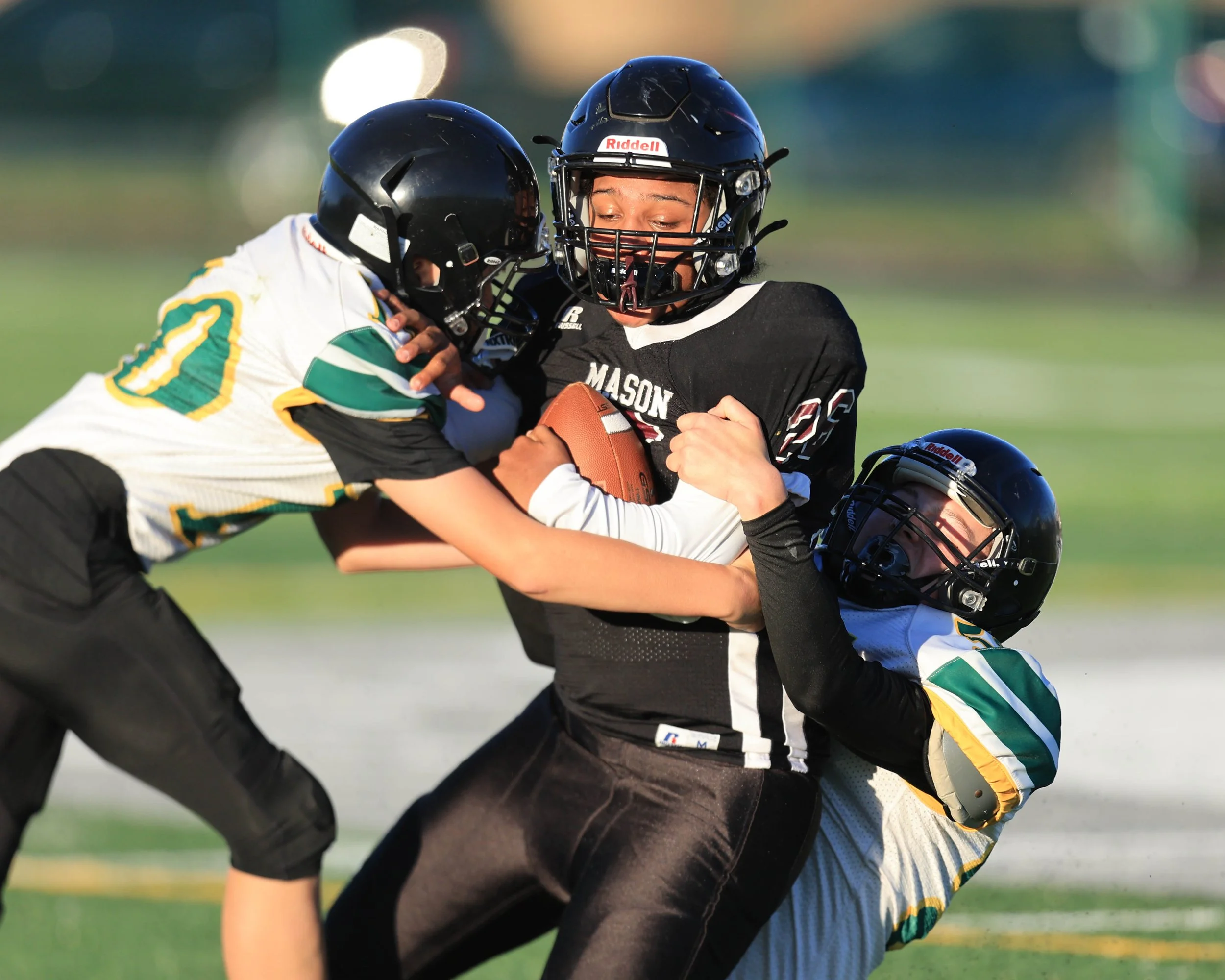 Mason #26 tackled by two Pierce players