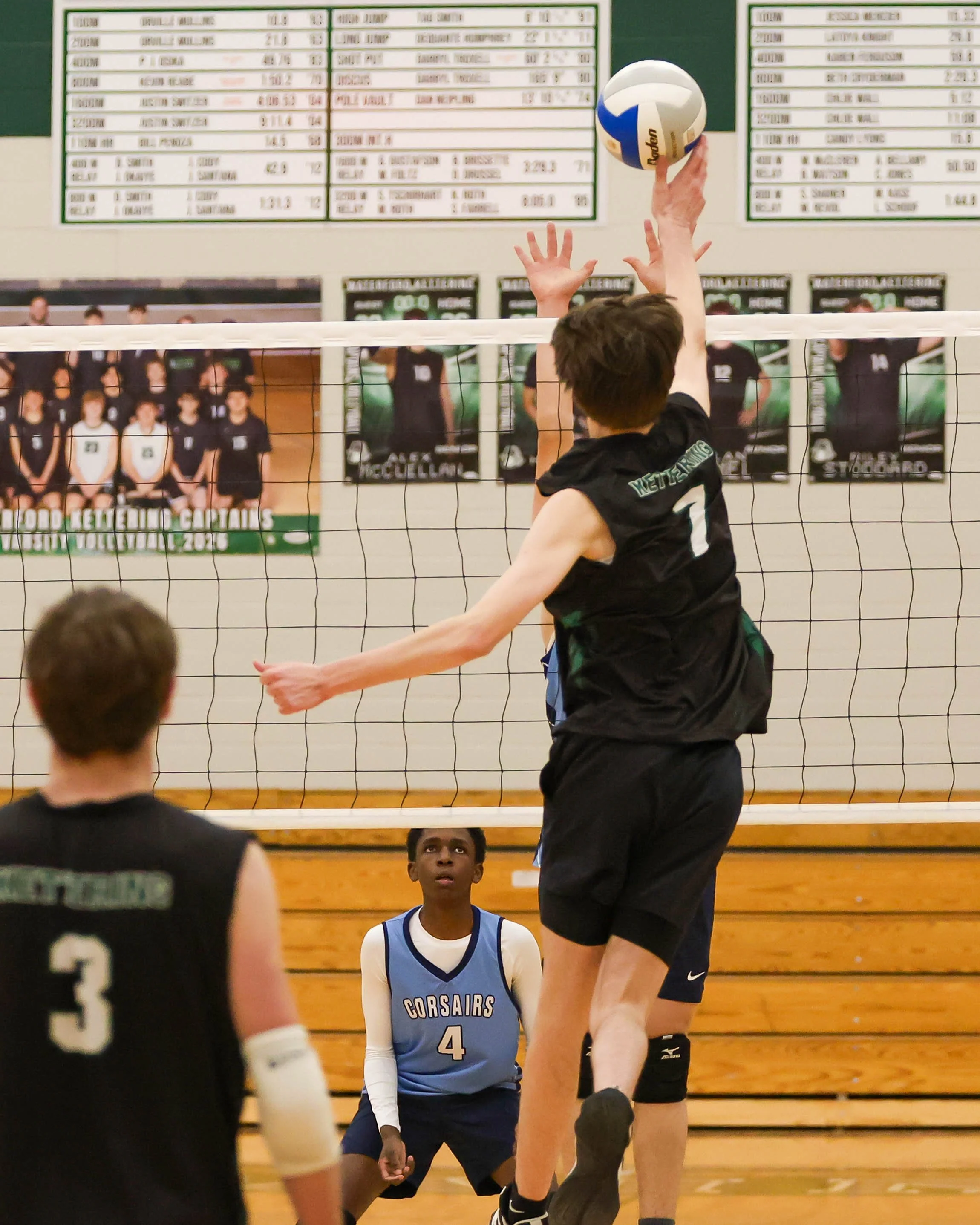 Kettering #7 taps the ball over the net