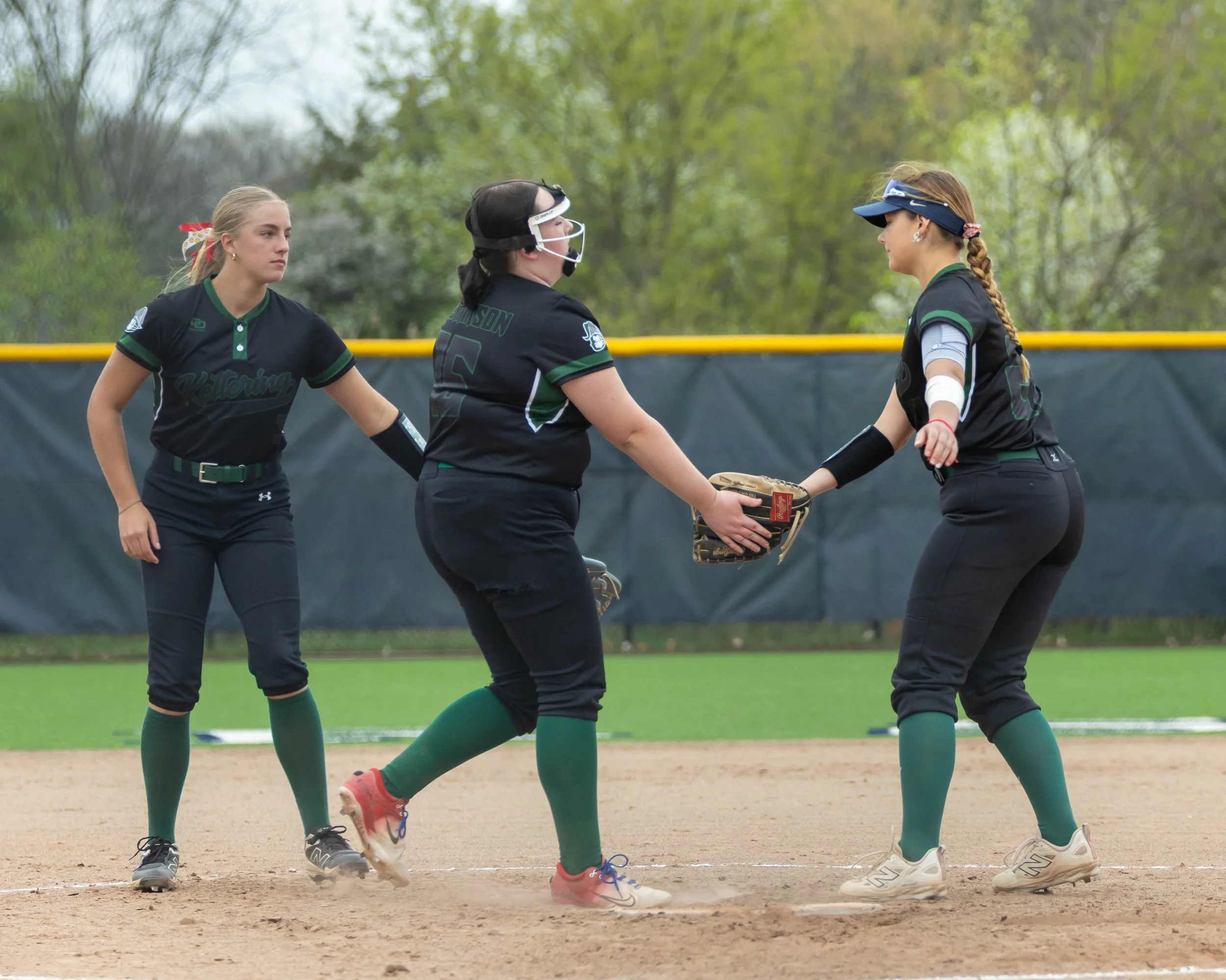 Kettering pitcher and first base shake hands after strike out