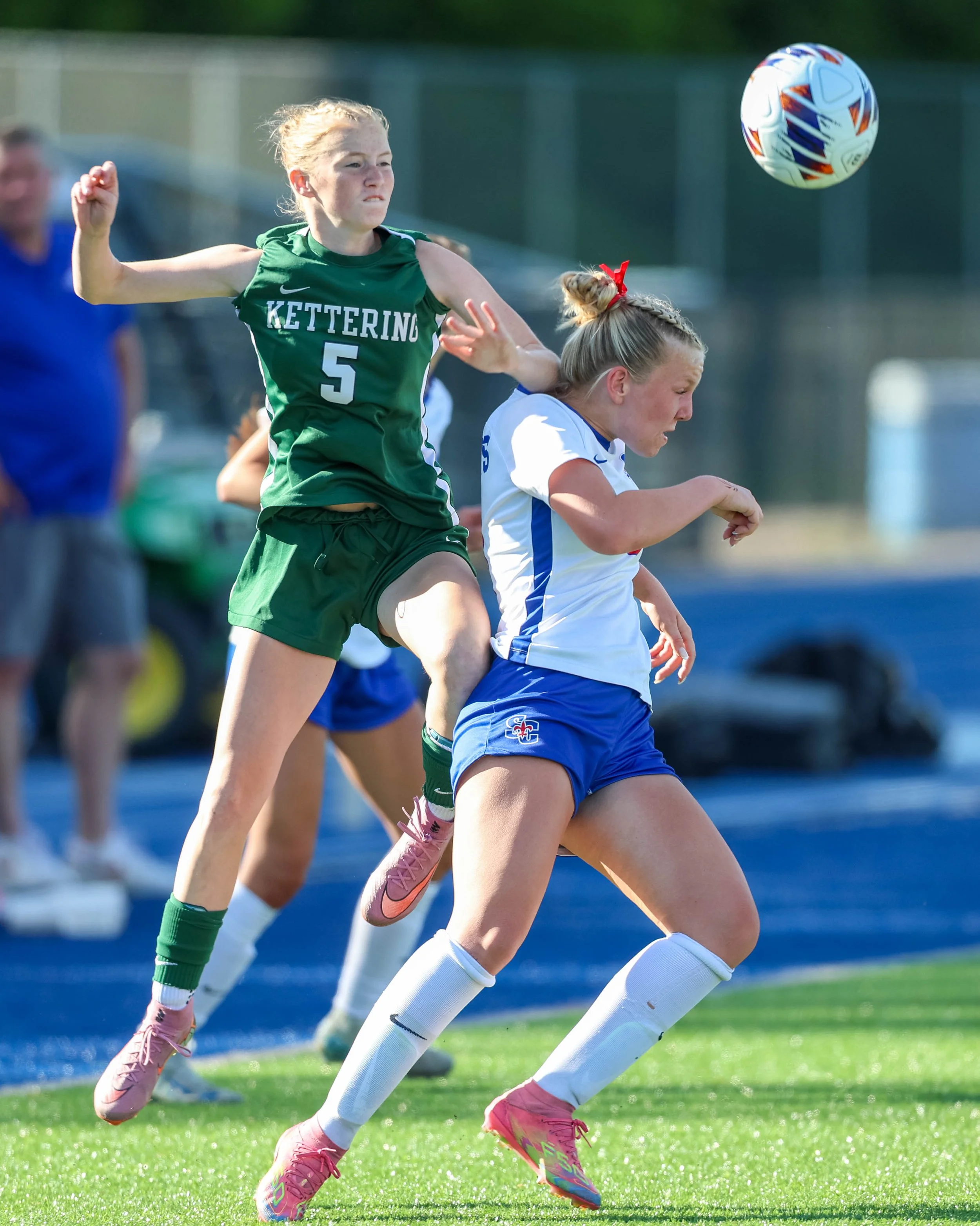 #5 with a defender and the ball in the air