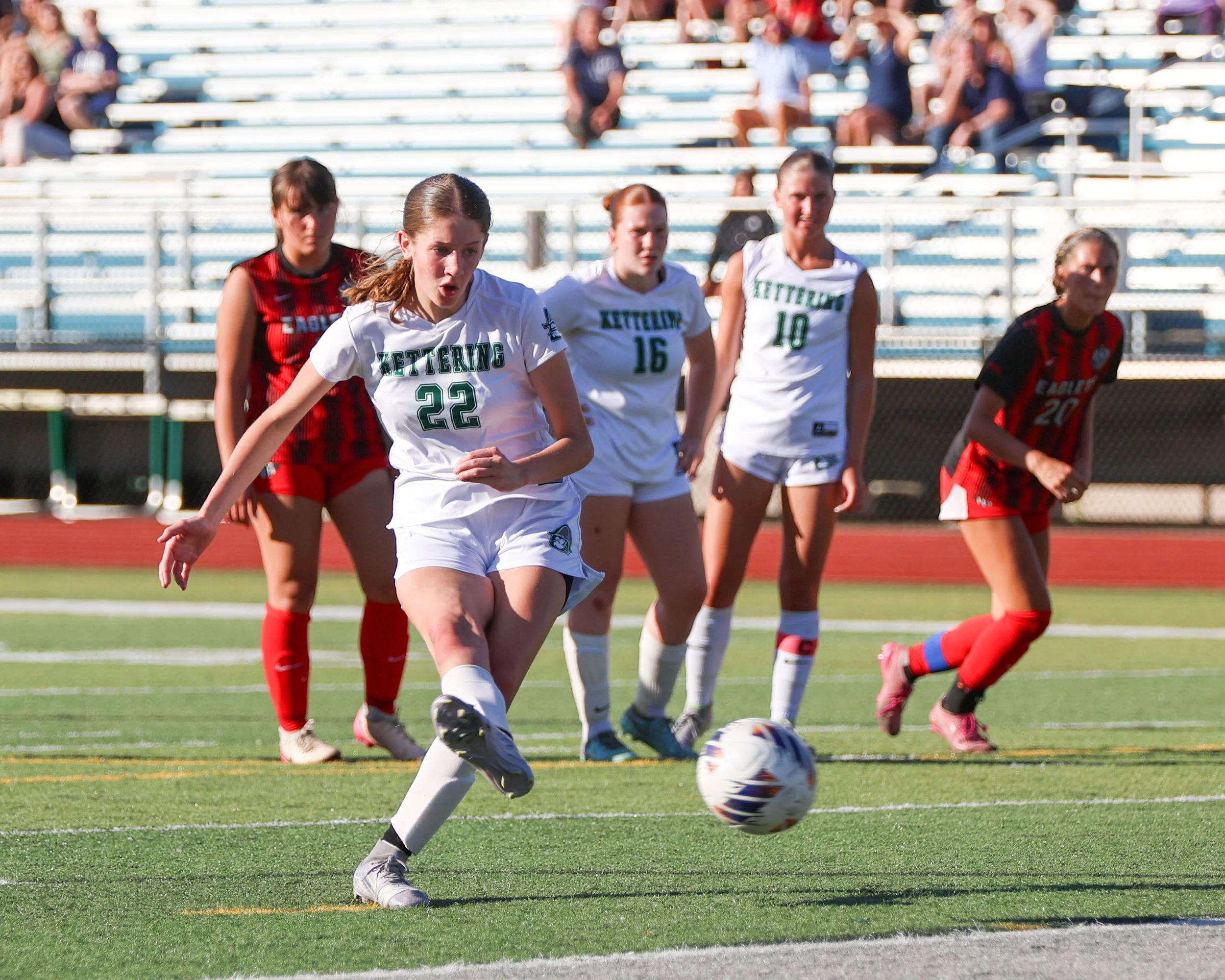 #22 kicks the ball towards the goal