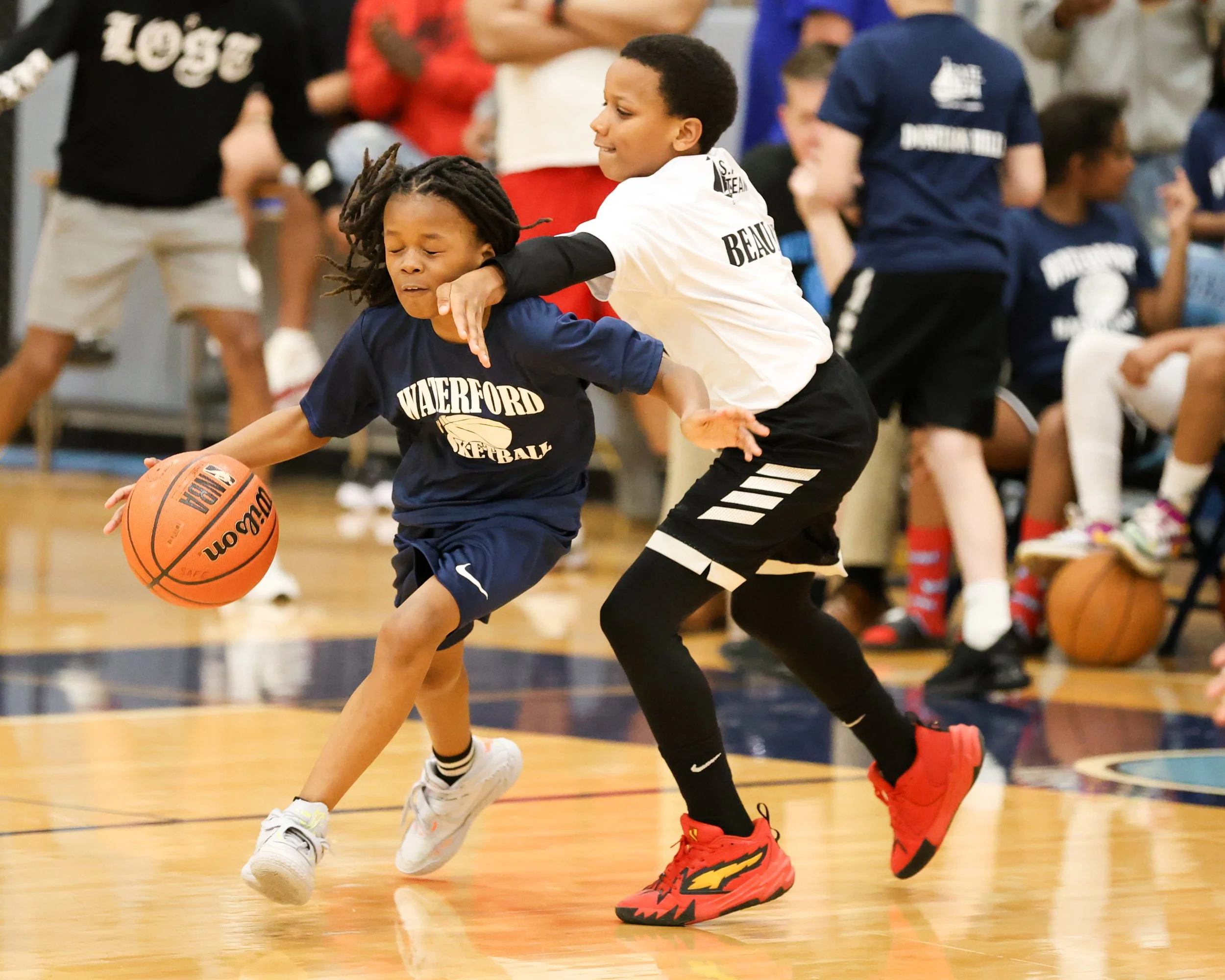 Donelson Hills boy dribbles the ball guarded by Beaumont boy