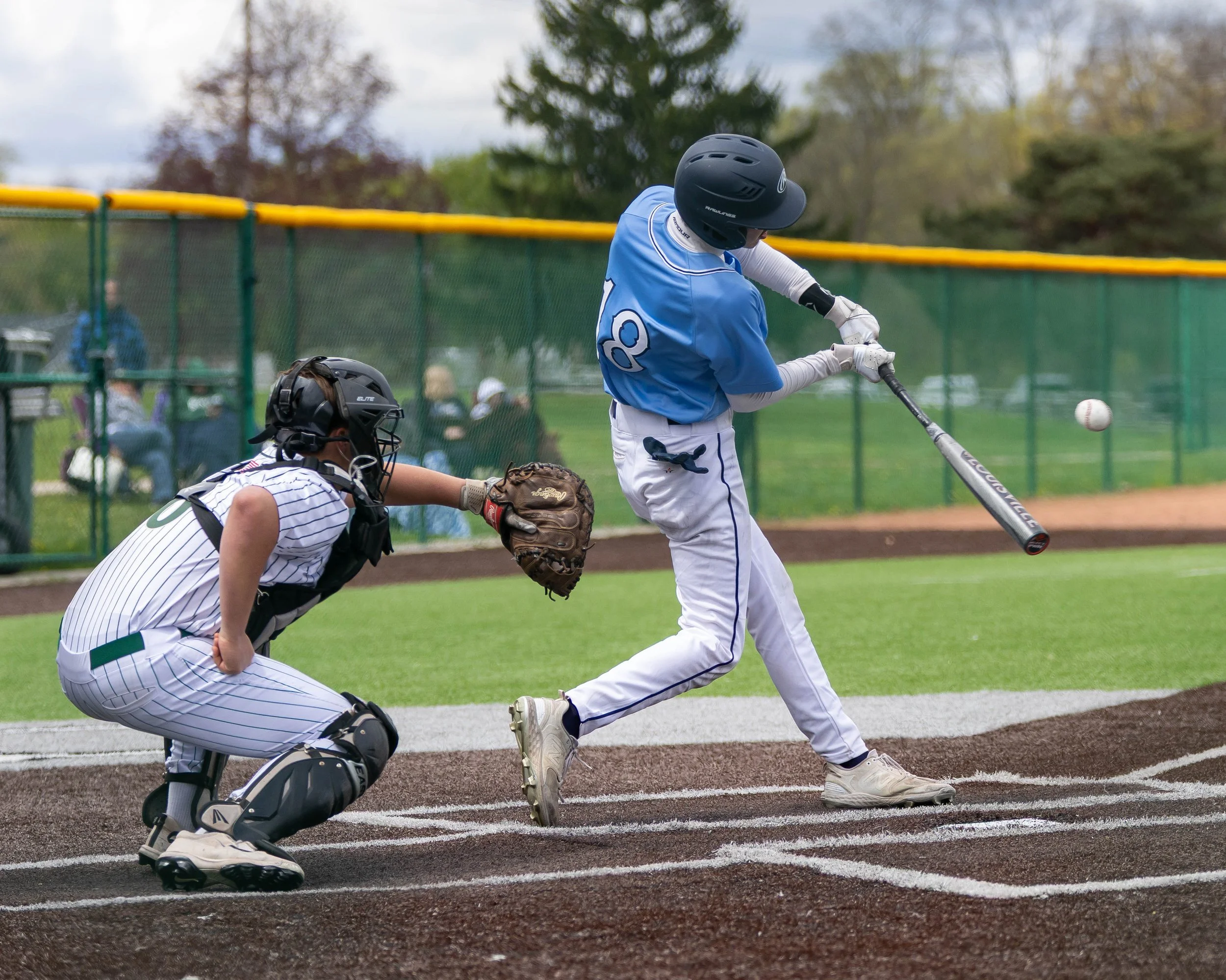 Mott #18 hits the ball at the plate