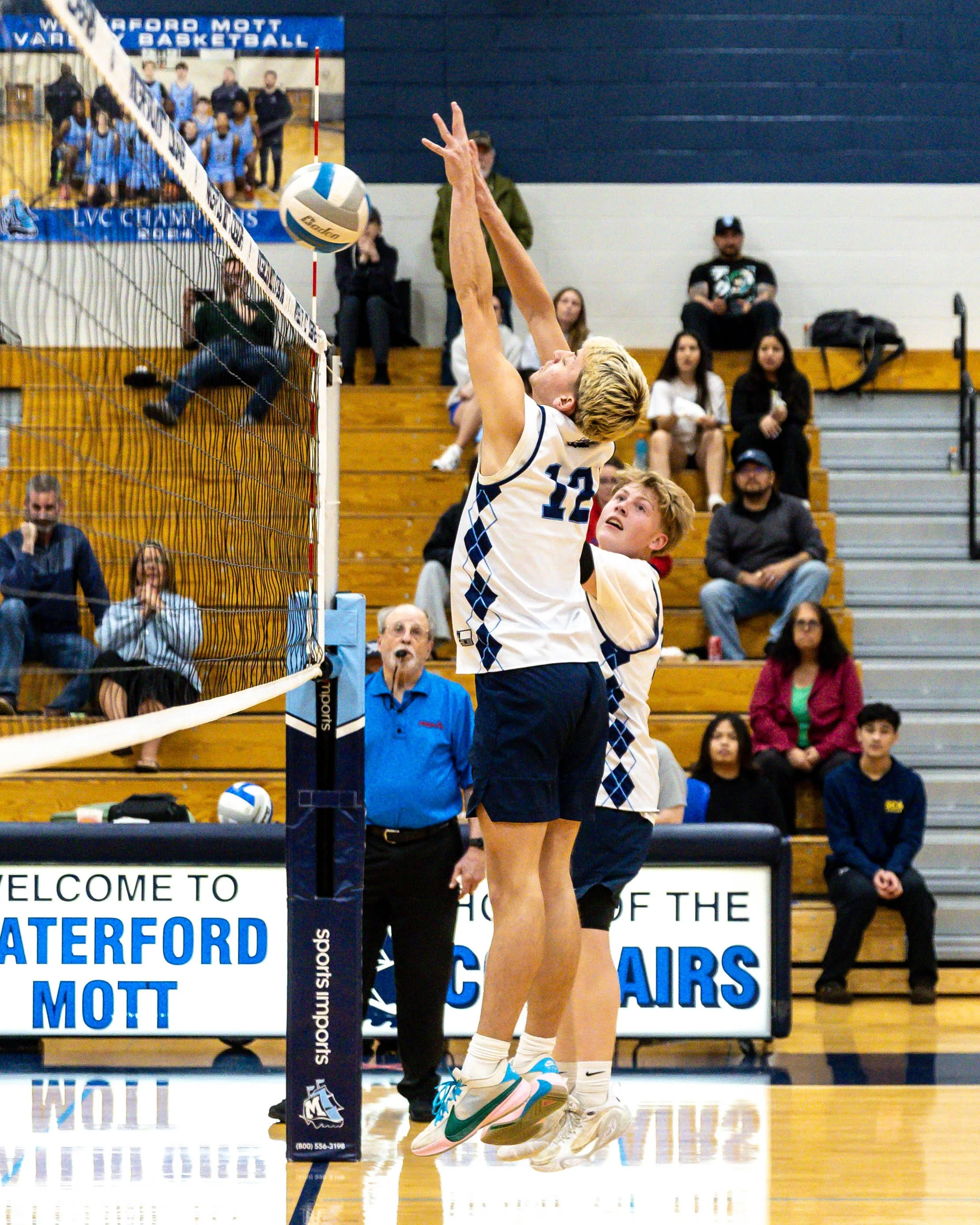 Mott 12 and #18 block the ball